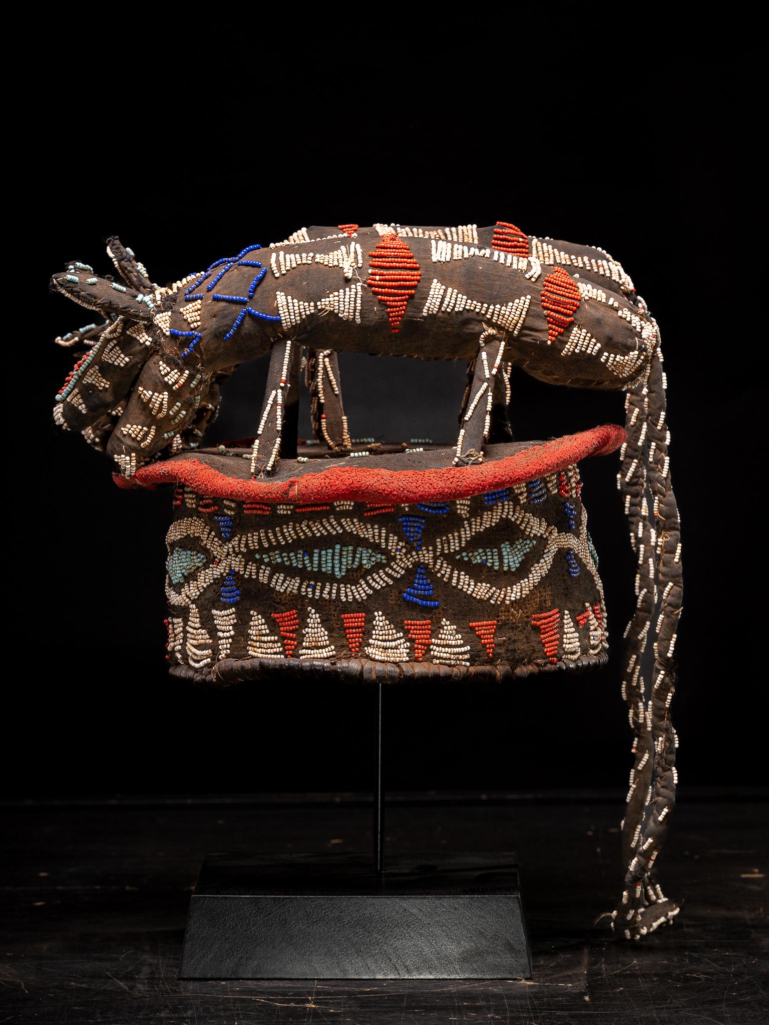 Bamileke Decorative Dance Crest, embroidered with European Glass Beads, Grasslands People, Cameroon. 

Private collection Brussels 

The raffia splint is covered with cloth and colourful miniature glass beads in various forms and sizes .The