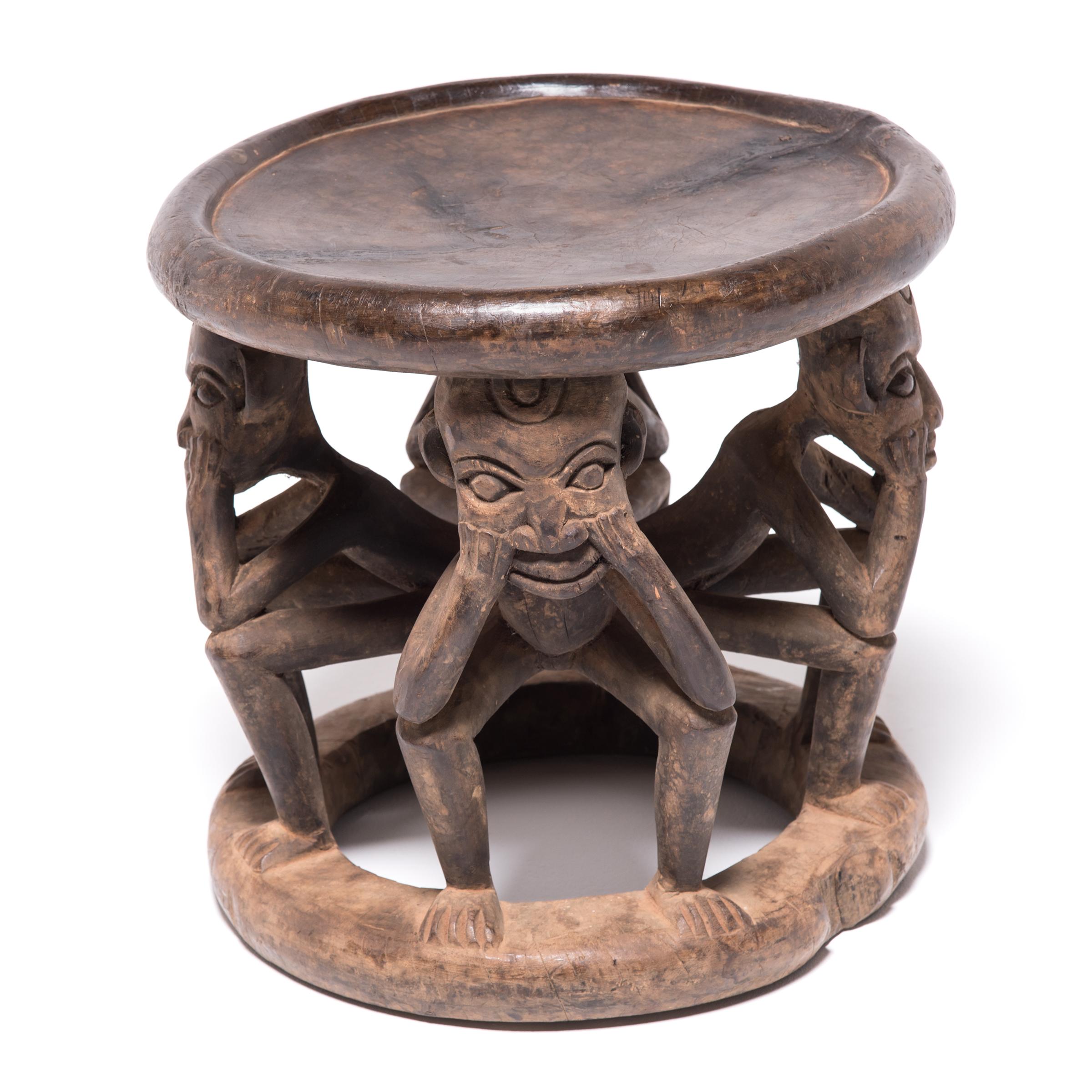 Marked by the telltale Bamileke rounded disc seat and base, this stool features a group of pondering human figures as its vertical supports instead of the more common abstract carvings. Created from a single tree trunk, the stool serves dual