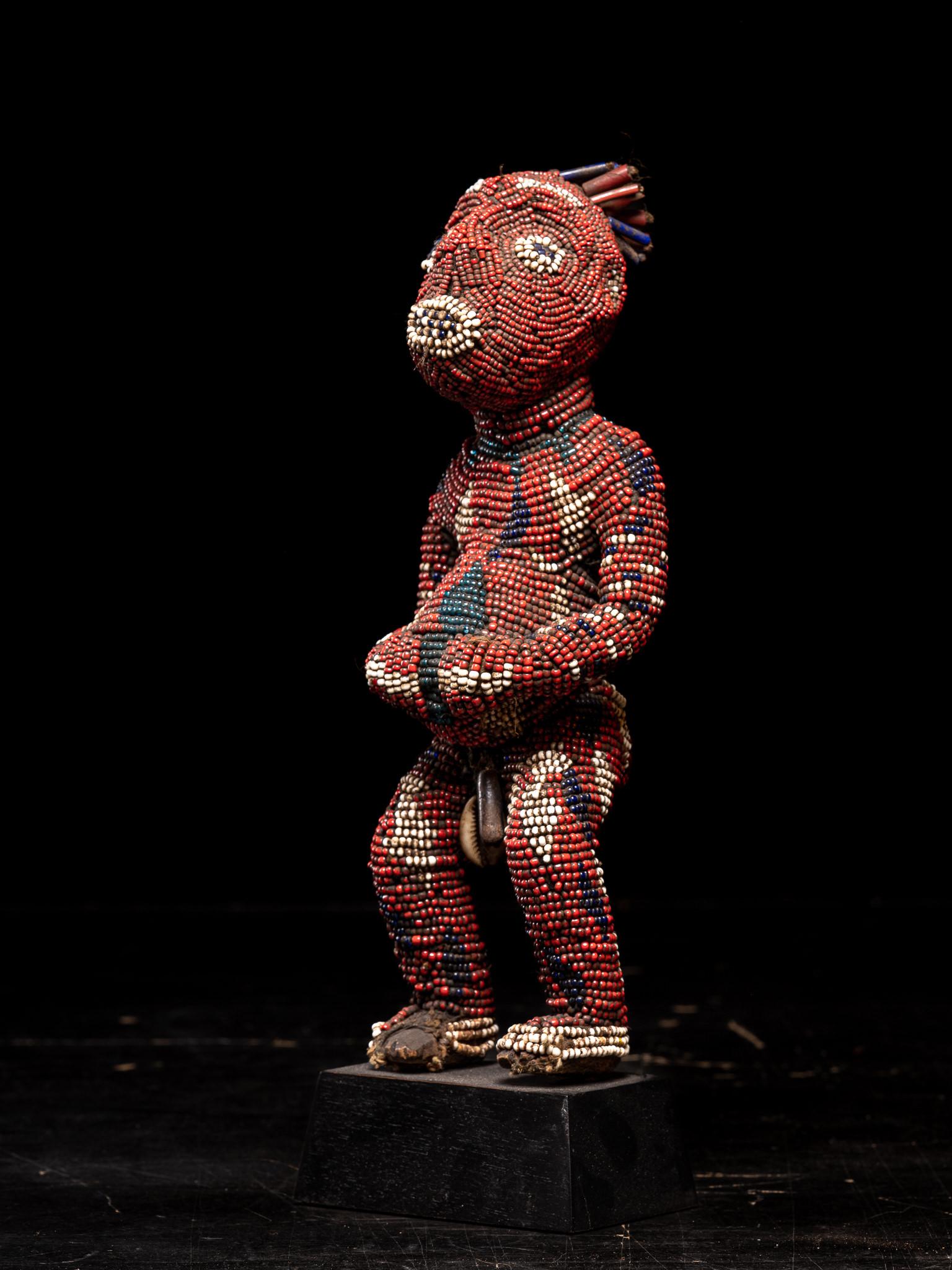Bamum Decorative Wooden Ancestor Figure embroidered with European Glass Beads, Grasslands People , Cameroon
Private collection Brussels
These commemorative statuettes ,representing ancestors ,were initially carved in wood to be then covered with a
