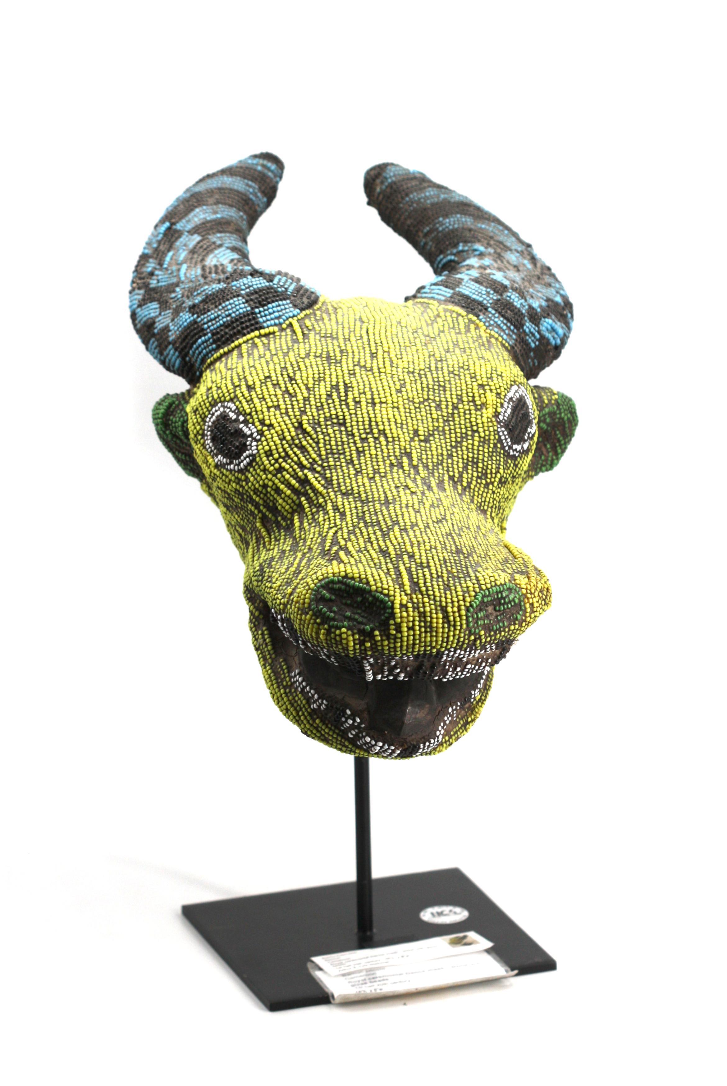 Bamun-Cameroon Royal Ox-Head Beaded Wood Dance Mask
First-half 20th Century. Multi-colored glass beads over wood, on a metal stand.
Height 16 in., Width 8 in., Depth 17 in.