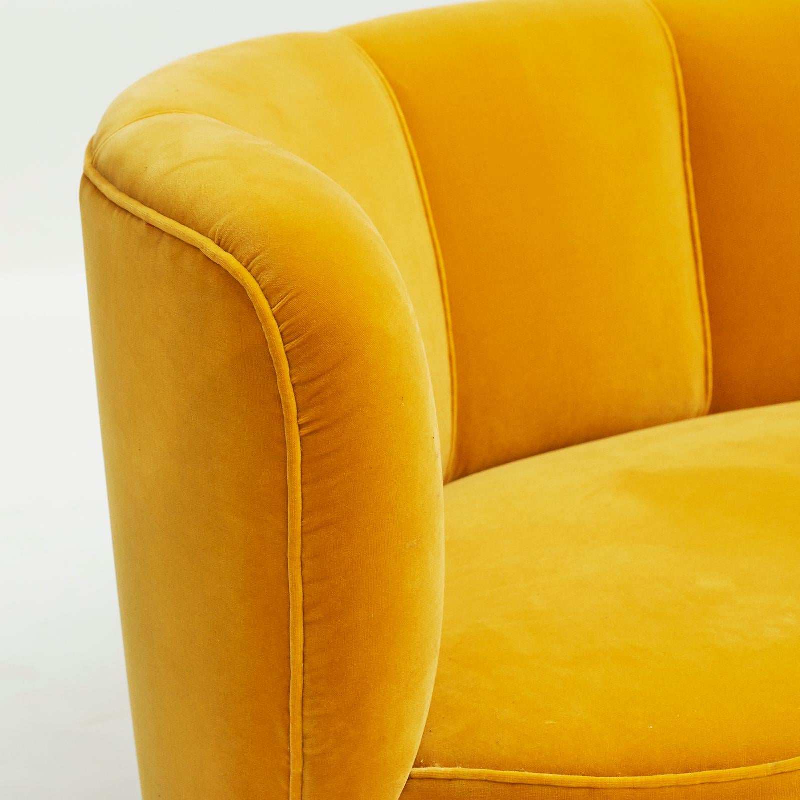 Banana sofa, Danish design circa 1950. Exceptionally beautiful sway, spherical mahogany legs, reupholstered in yellow velor by Manuel Canovas.