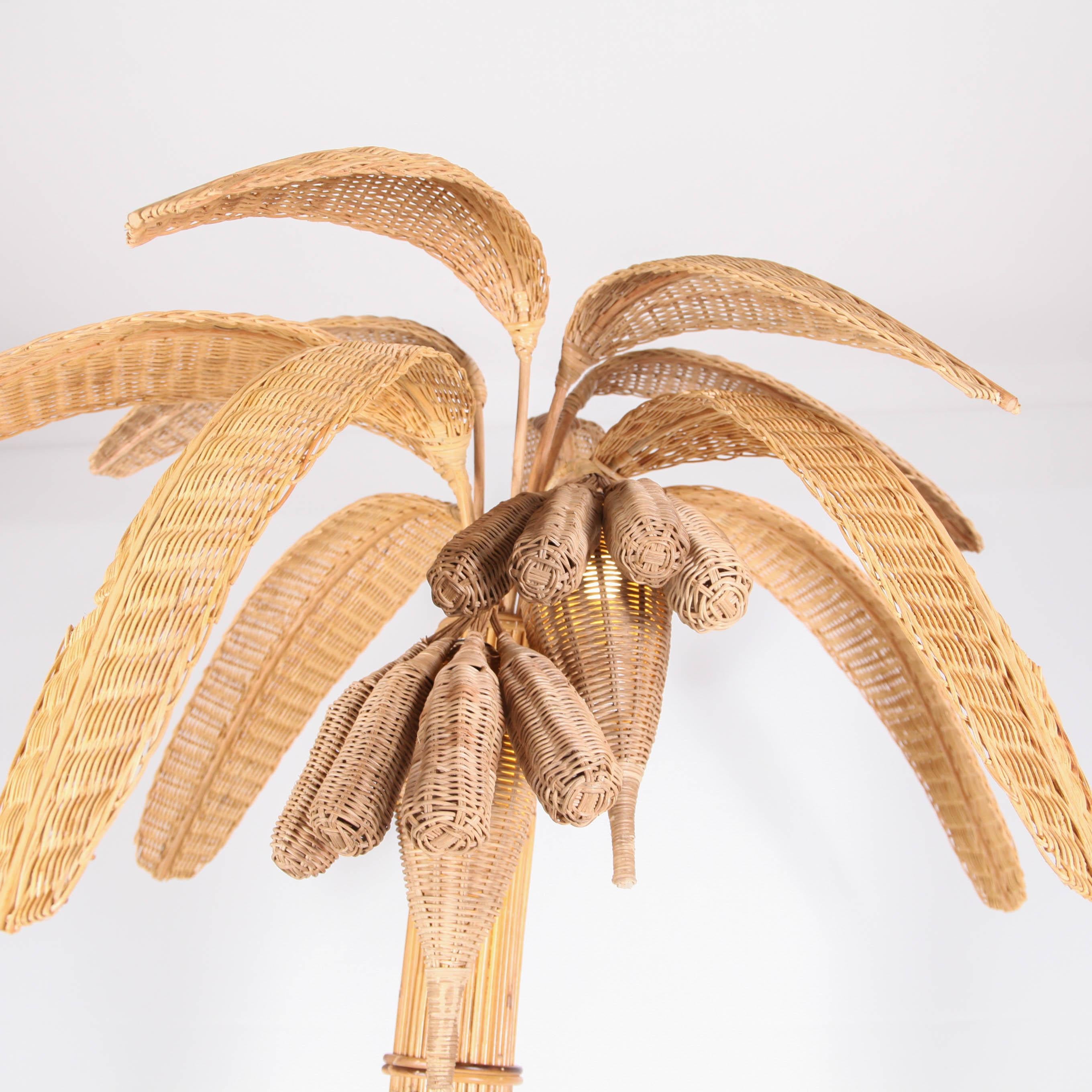 Beautiful handmade banana tree floor lamp in natural rattan with 2 lights (in each flower).
This is a very unique lamp. It gives a nice soft light and something special wherever you place it. High quality of craftsmanship, entirely hand made.