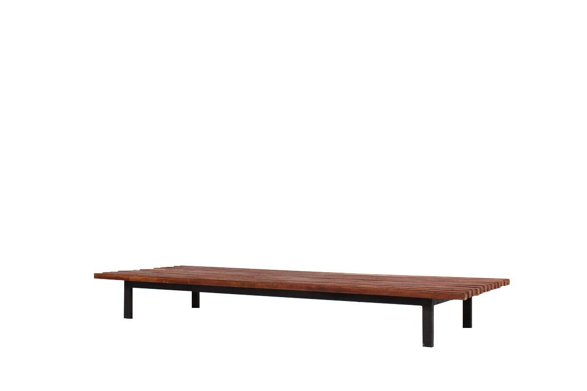 The Cansado bench was designed by Charlotte Perriand, Edition Steph Simon. It is a solid mahogany bench with a black lacquered metal frame.
Provenance: Miferma, Cité Cansado, Mauritania.

Dimensions : 
- W: 190 cm
- D : 70.5 cm
- H : 24 cm