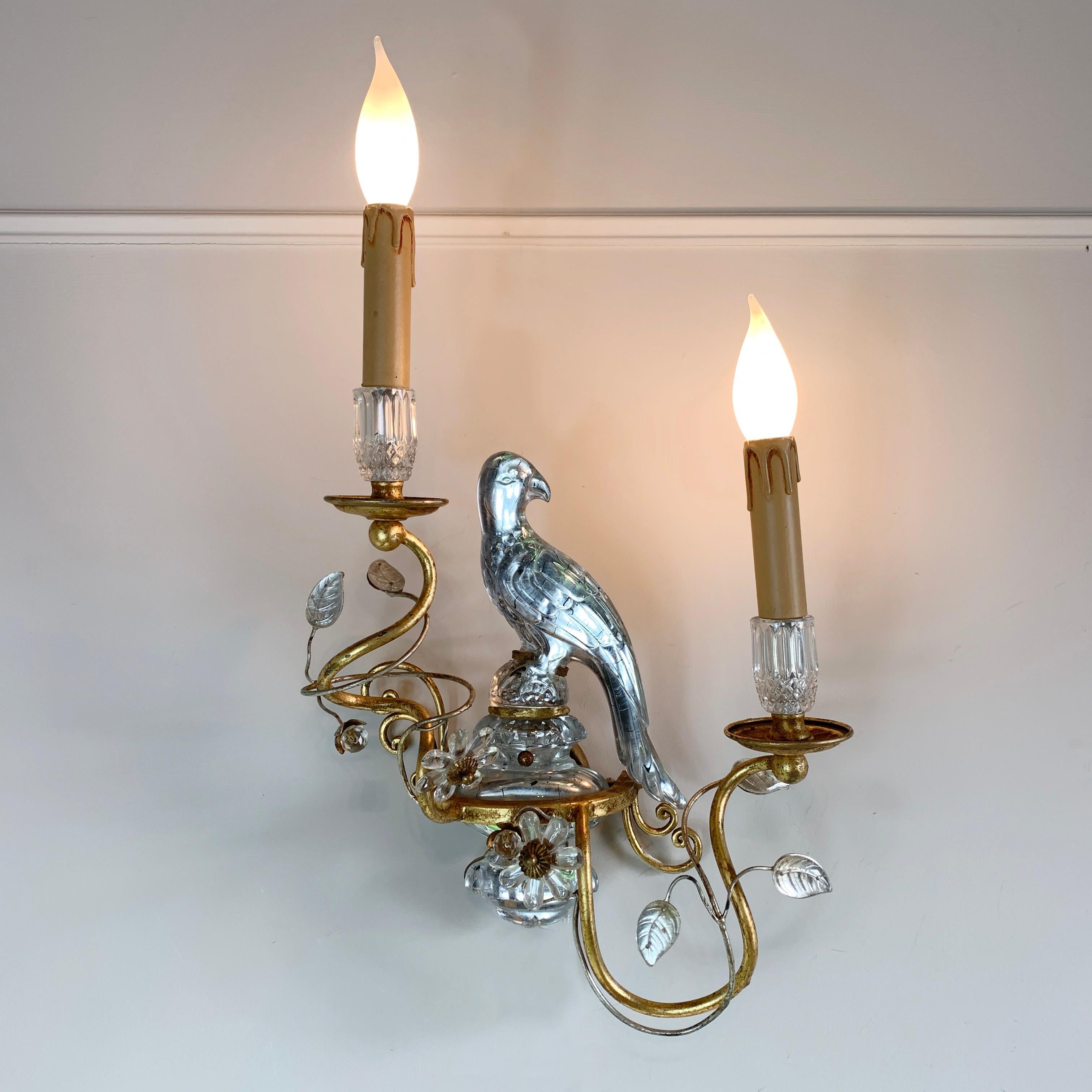 An incredible Italian wall light by Banci Firenze, dating to the 1960’s the crystal parrot is at the centre, surrounded by crystal flowers and buds, all extending from spiralling gilt branches, the two single bulb holders extend upward, each with