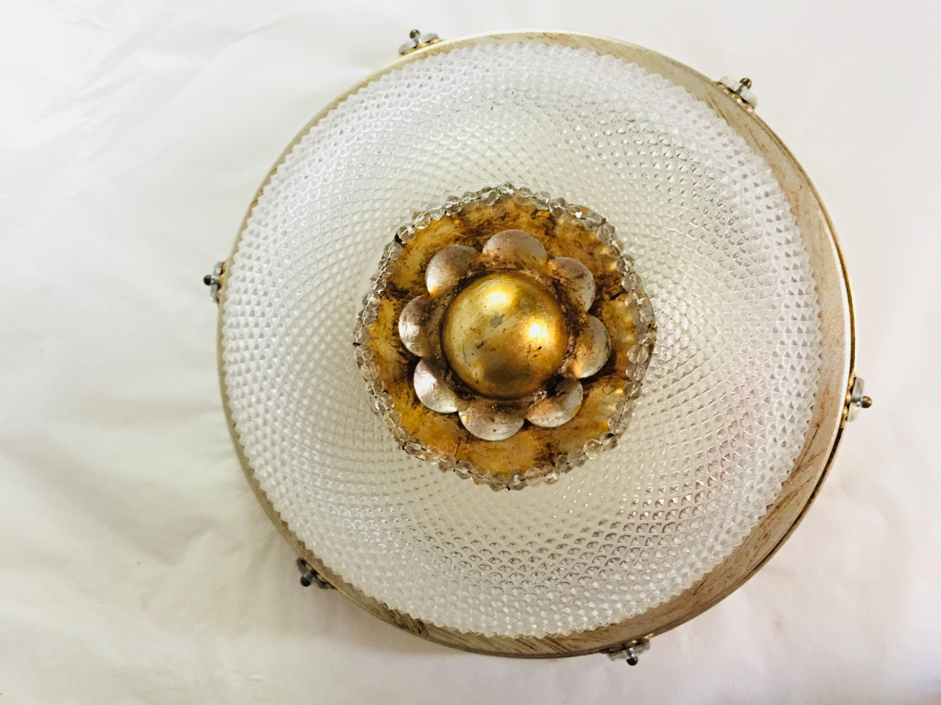 Vintage Italian two-light ceiling fixture by Banci, manufactured by Banci Firenze. A circular crystal cup is decorated with cut-diamond patterns and an antique finish mecca gilded iron profile centered by a mecca gilded iron flower. 
Inside the