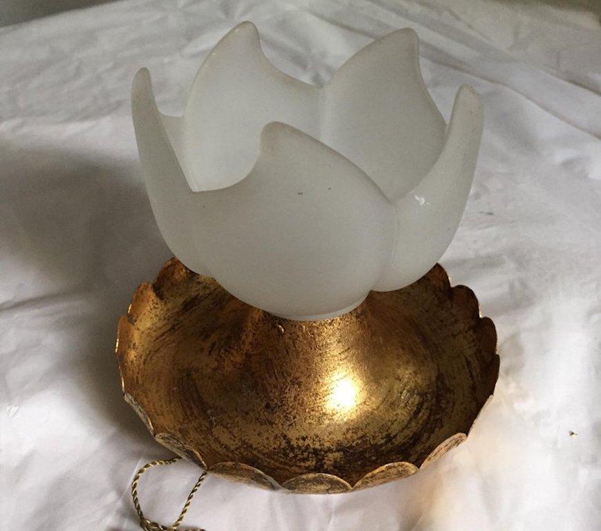 Vintage Italian sconce, ceiling fixture dating back to 1980s, Gold leaf Iron circular structure and frosted glass flower shade. One light, wired for Italian standards, for an Edison 14 bulb. Two items available. Suitable as small wall- light or