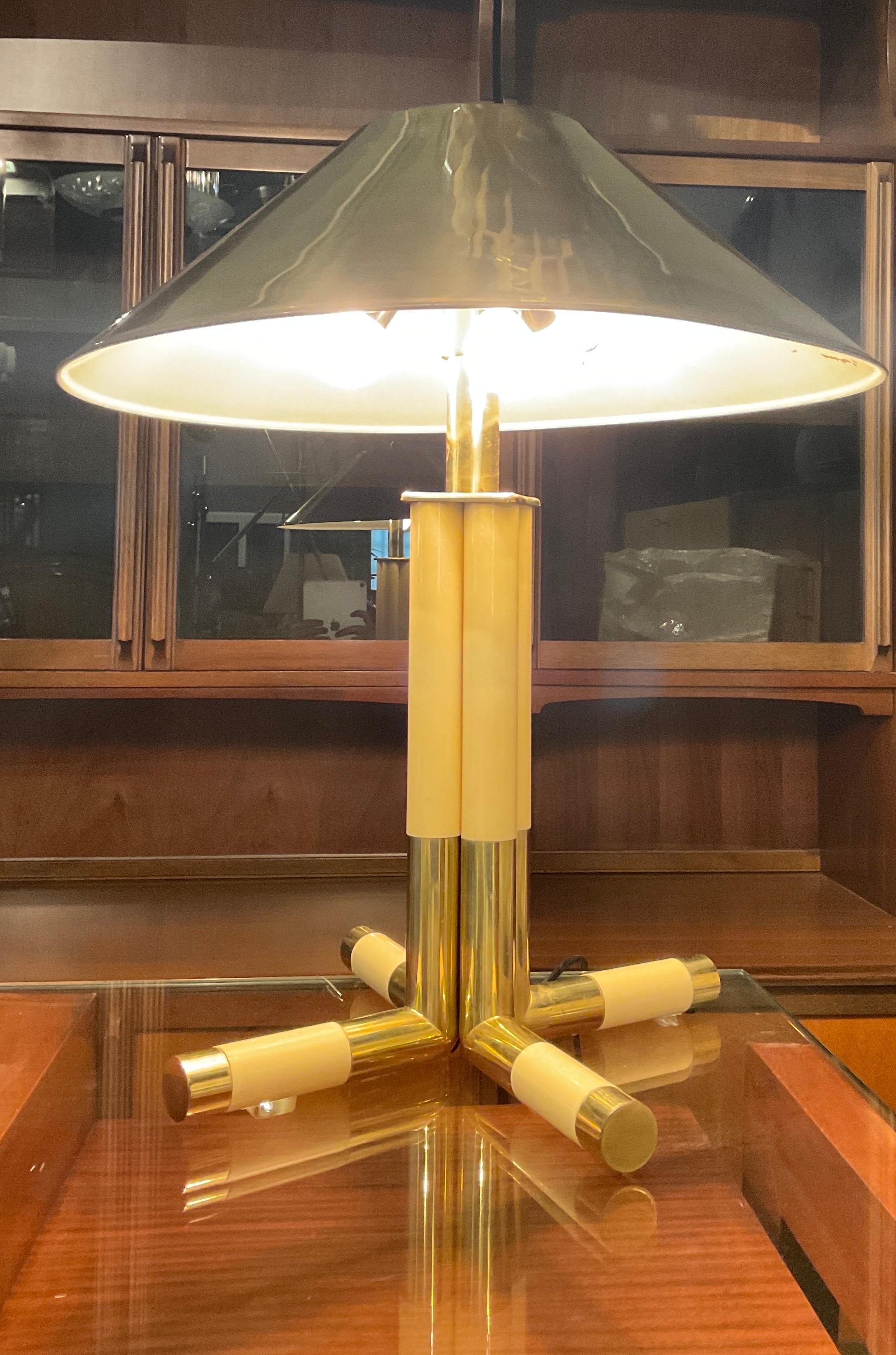 Banci Giovanni table lamp in brass and ivory, Florence 1970 Formed by four tubular elements moveable in brass and white plastic material, golden metal hat, height 63 cm. In good condition with small wear caused by years and use.