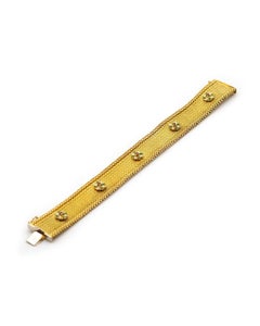 Band bracelet signed Unoaerre with ruby enameld flowers in 18k gold