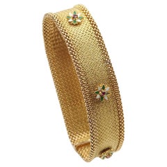 Band bracelet signed Unoaerre with ruby enameld flowers in 18k gold