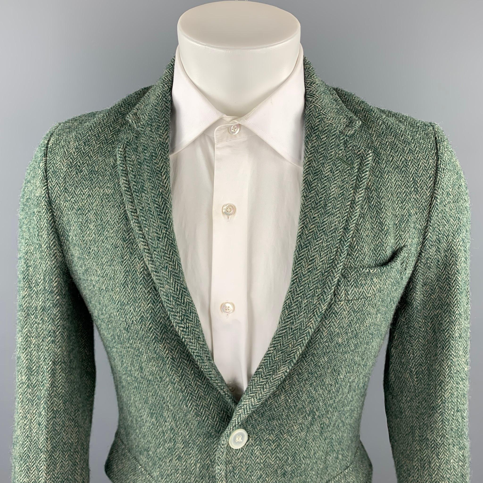 BAND OF OUTSIDERS sport coat comes in a green herringbone wool featuring a notch lapel, elbow patches, flap pockets, and a two button closure. Made in Italy.

Very Good Pre-Owned Condition.
Marked: 2

Measurements:

Shoulder: 16.5 in. 
Chest: 38 in.
