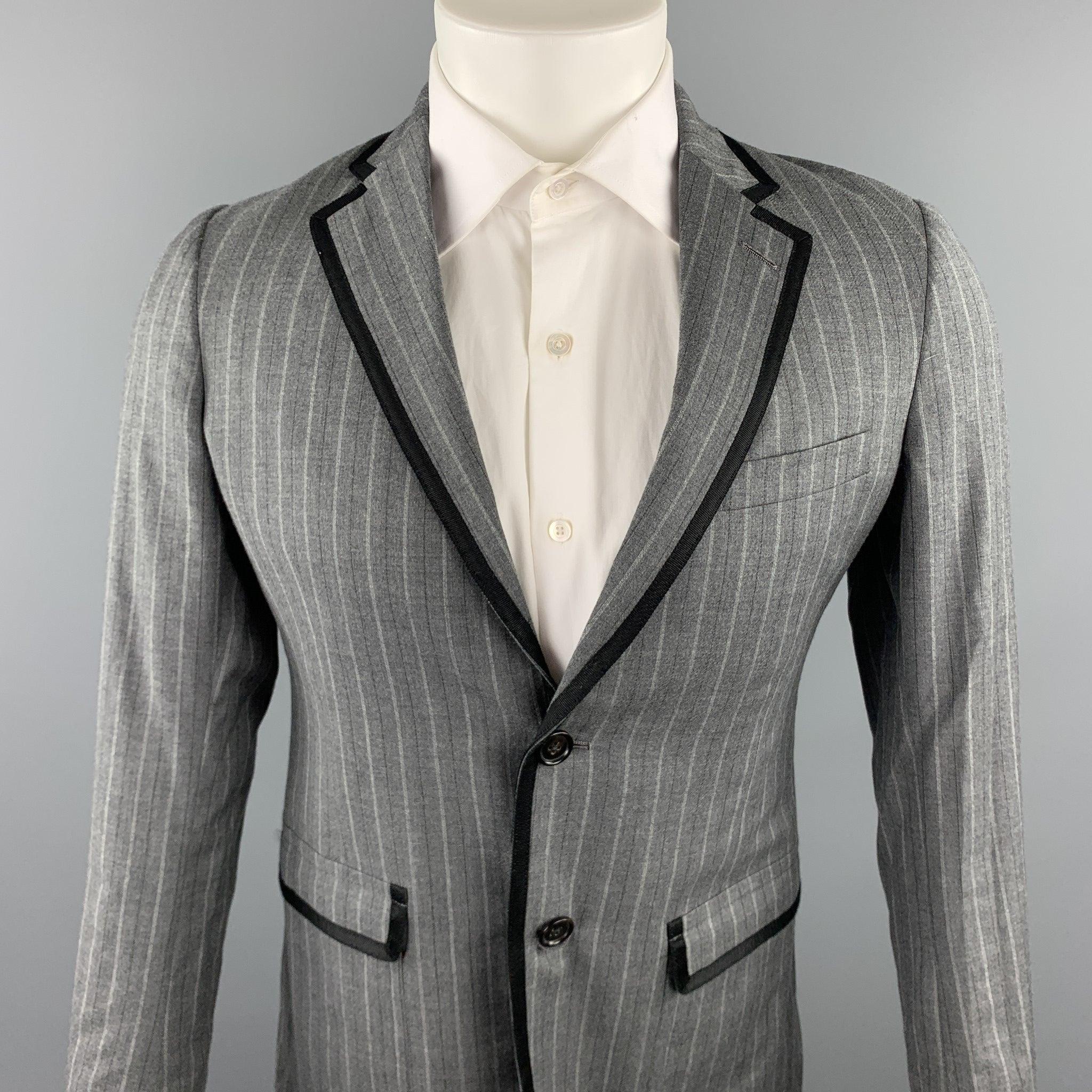 BAND OF OUTSIDERS sport coat comes in a grey stripe wool with a full liner featuring a notch lapel, black ribbon trim, flap pockets, and double button closure. Made in USA.Very Good
Pre-Owned Condition. 

Marked:   1 

Measurements: 
 
Shoulder: 16