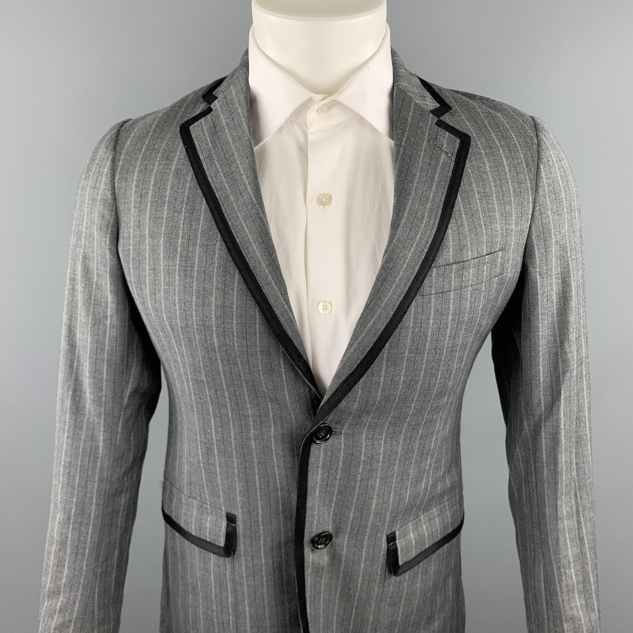 BAND OF OUTSIDERS sport coat comes in a grey stripe wool with a full liner featuring a notch lapel, black ribbon trim, flap pockets, and double button closure. Made in USA.

Very Good Pre-Owned Condition.
Marked: 1

Measurements:

Shoulder: 16 in.
