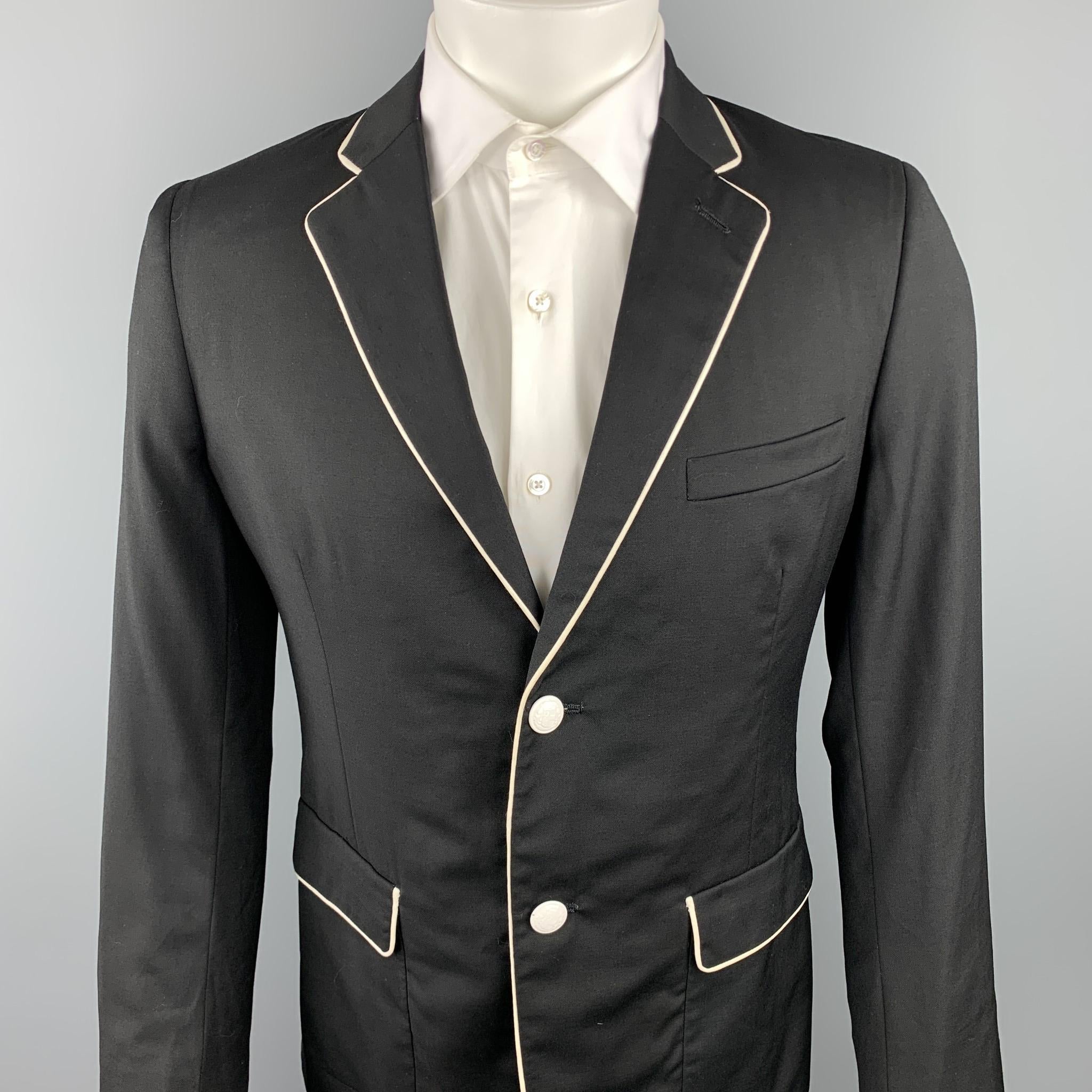 BAND OF OUTSIDERS sport coat comes in a black wool with white piping featuring a notch lapel, stripe print liner, flap pockets, and a two button closure. Made in USA.

Excellent Pre-Owned Condition.
Marked: 3

Measurements:

Shoulder: 17.5 in.