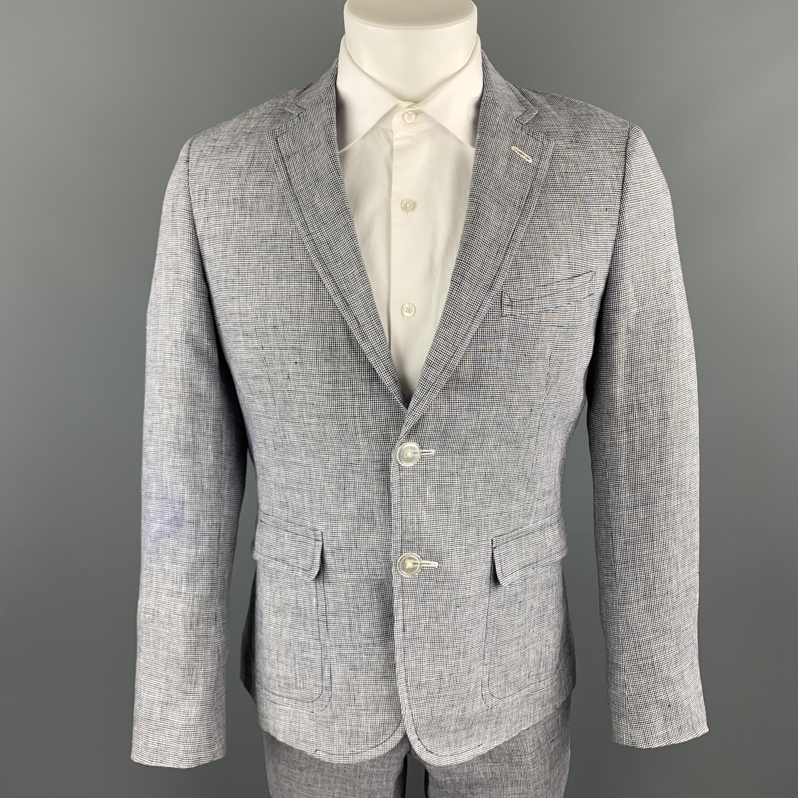 BAND OF OUTSIDERS suit comes in white and navy micro houndstooth linen and includes a single breasted, two button sport coat with a notch lapel and  matching flat front trousers. Made in the USA.

Excellent Pre-Owned Condition.
Marked: