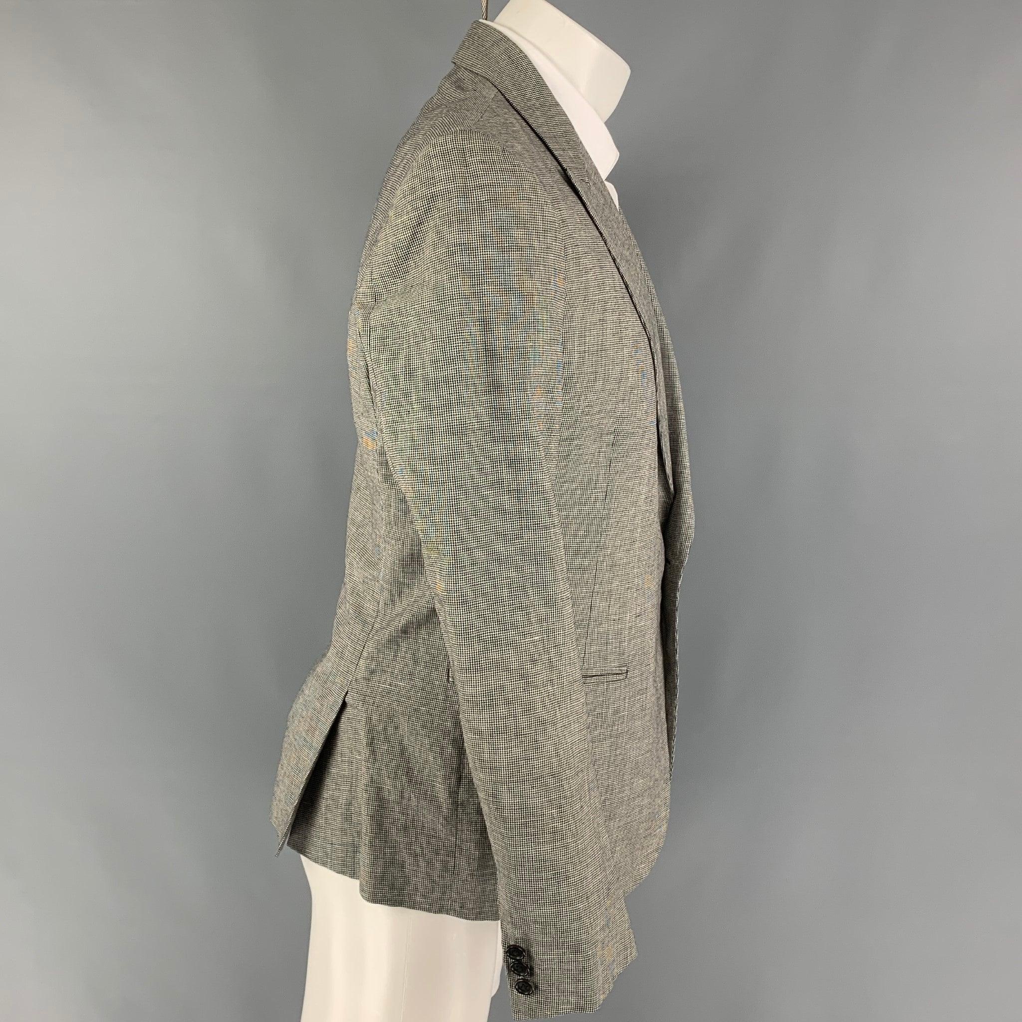 BAND OF OUTSIDERS sport coat comes in a black & white houndstooth wool with a full liner featuring a peak lapel, slit pockets, double back vent, and a single button closure.
Very Good
Pre-Owned Condition. 

Marked:   4 

Measurements: 
