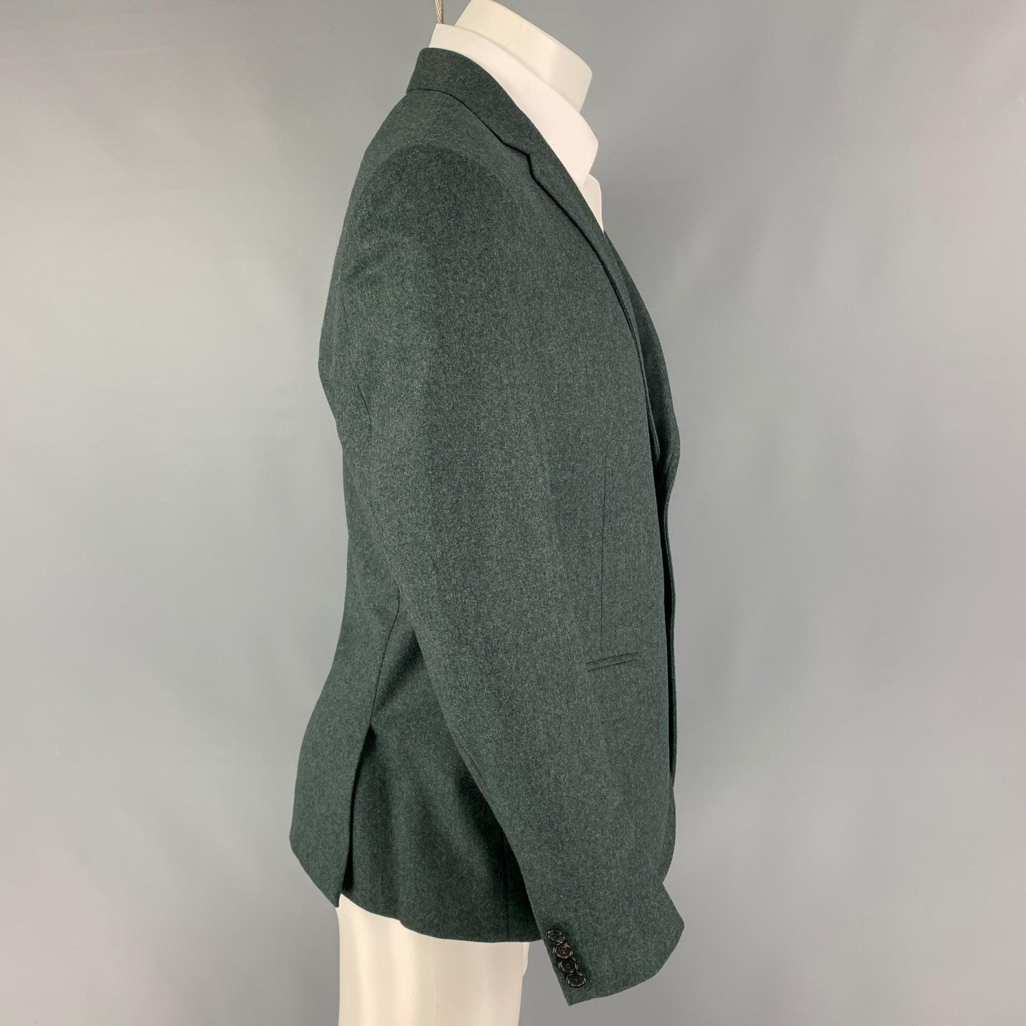 BAND OF OUTSIDERS sport coat comes in a green wool with a full liner featuring a notch lapel, flap pockets, double back vent, and a double button closure.
Very Good
Pre-Owned Condition. 

Marked:   4 

Measurements: 
 
Shoulder: 18 inches Chest: 40