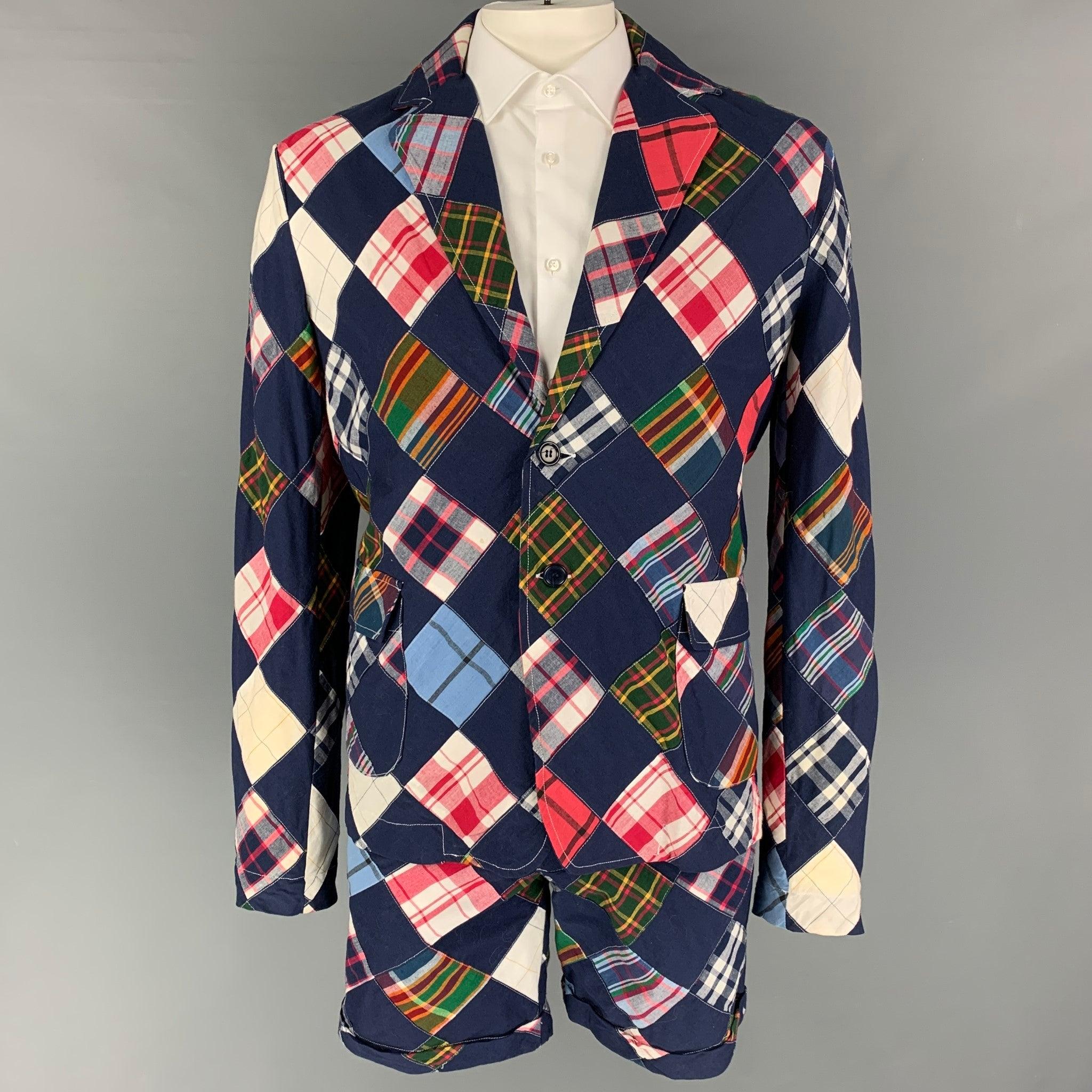 BAND OF OUTSIDERS
'This Is Not A Polo Shirt' suit comes in a navy & multi-color patchwork cotton and includes a single breasted, double button sport coat with a notch lapel and matching flat front shorts. Made in USA.Very Good Pre-Owned Condition.