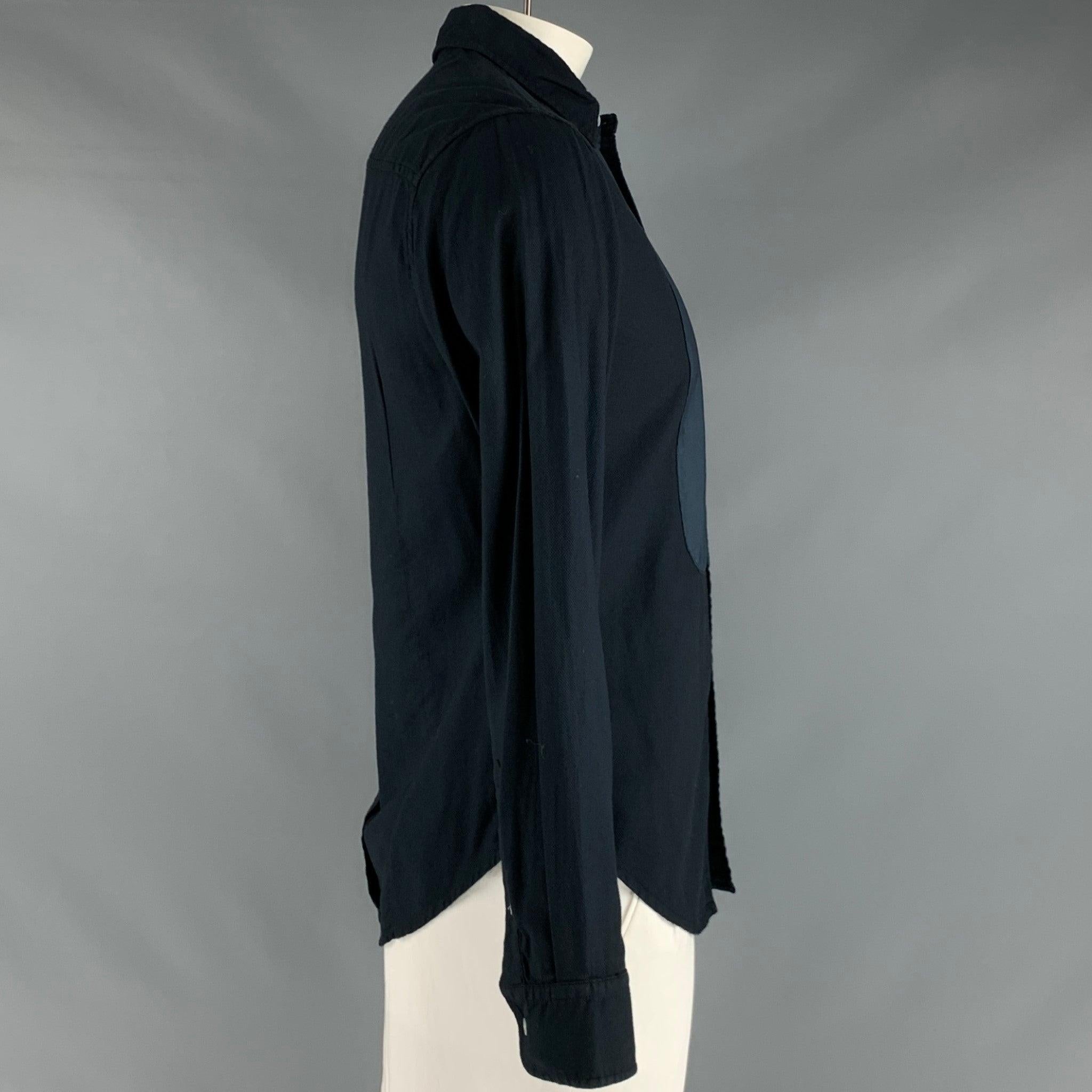 BAND OF OUTSIDERS long sleeve shirt
in a black cotton fabric featuring blue bib front, spread collar, and button closure.Very Good Pre-Owned Condition. Minor signs of wear. 

Marked:   L 

Measurements: 
 
Shoulder: 17.5 inches Chest: 42 inches