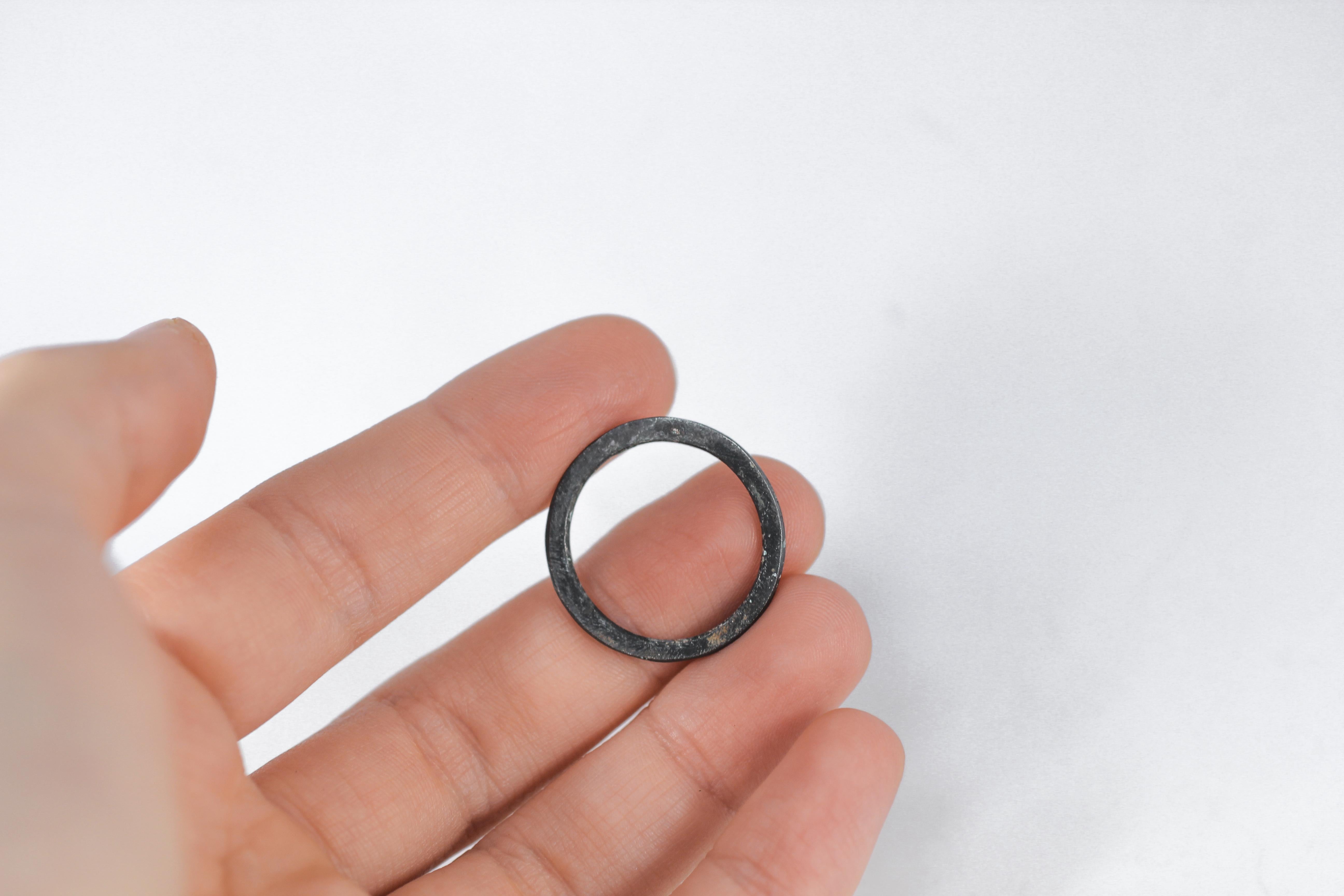 Fashion ring band in Simplicity Medium Disk contemporary design in oxidized/blackened sterling silver. Can be worn as a bridal or wedding ring or a stacking fashion ring.  

Process: This striking ring is first hand-forged in 21k gold, then cast in