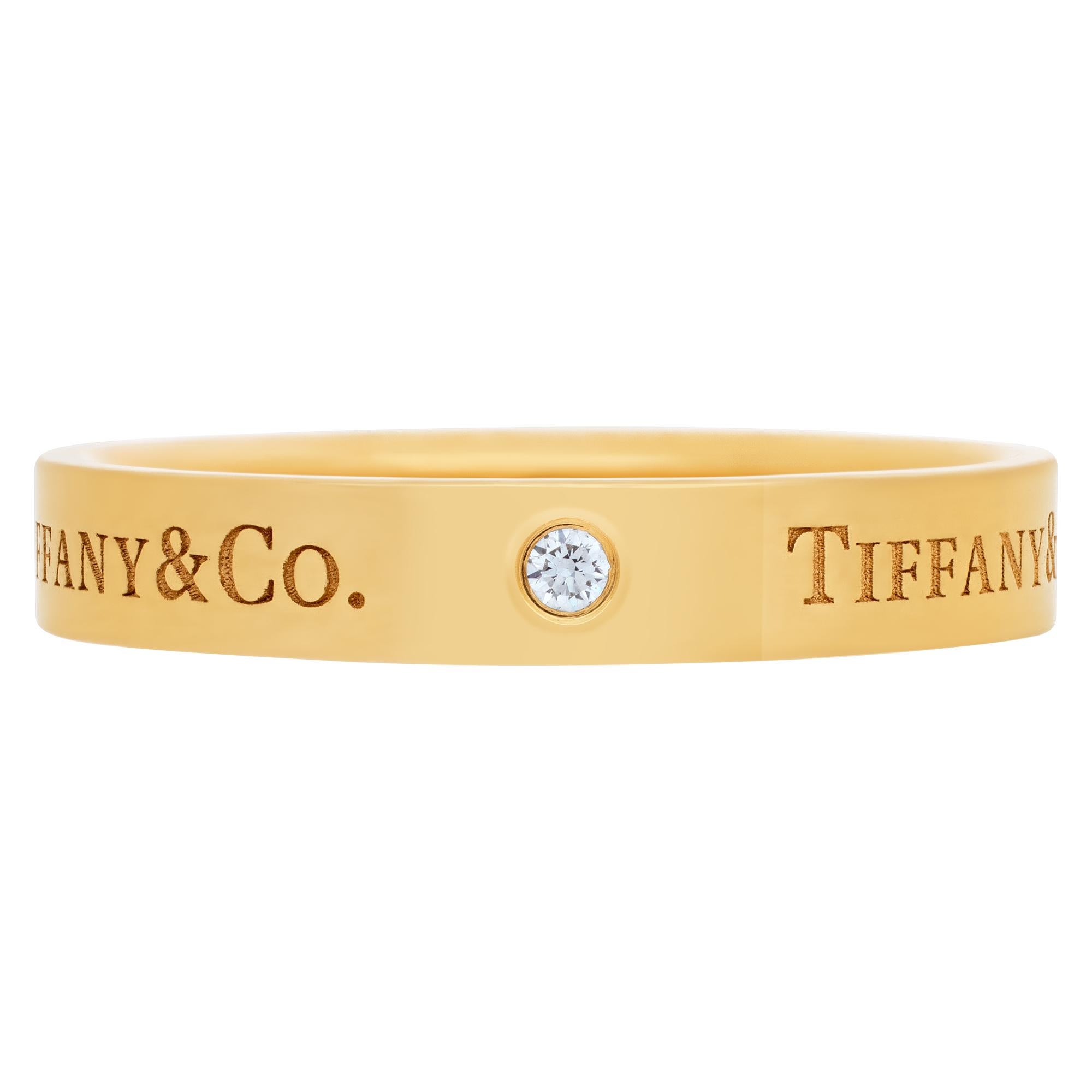 Tiffany & Co. 18k Yellow Gold Band ring with three round brilliant diamonds. 4 mm wide. Size 9.75.<br /><br />This Tiffany & Co. ring is currently size 9.75 and some items can be sized up or down, please ask! It weighs 3.7 pennyweights and is 18k.
