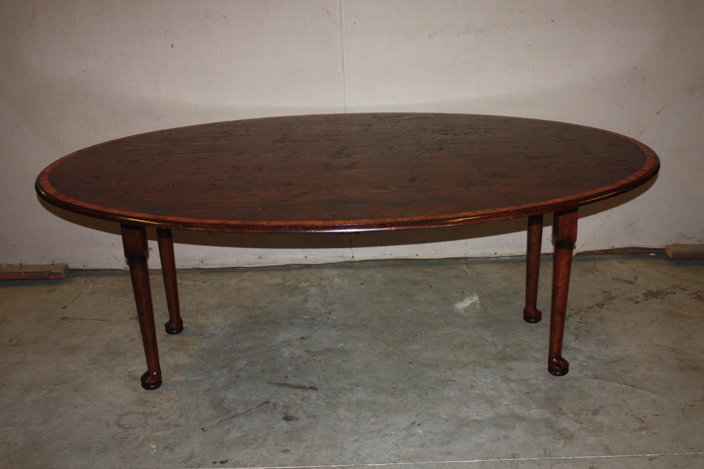 This is a very nice English oak padfoot banded table I have made in England. This is the 7' table. The oak displays maximum character in a rich tone. The yew wood banding contrasts nicely with the oak.