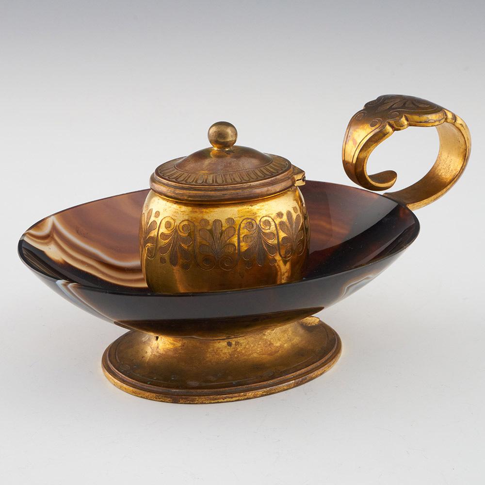 Heading : A 19th century banded agate and ormolu bronze inkwell
Date : 1880-1910
Origin : France
Decoration : The handle and inkwell with engraved foliate design. Original glass liner
Size :  Height 7.5cm , length
Condition : Exemplary
Restoration :