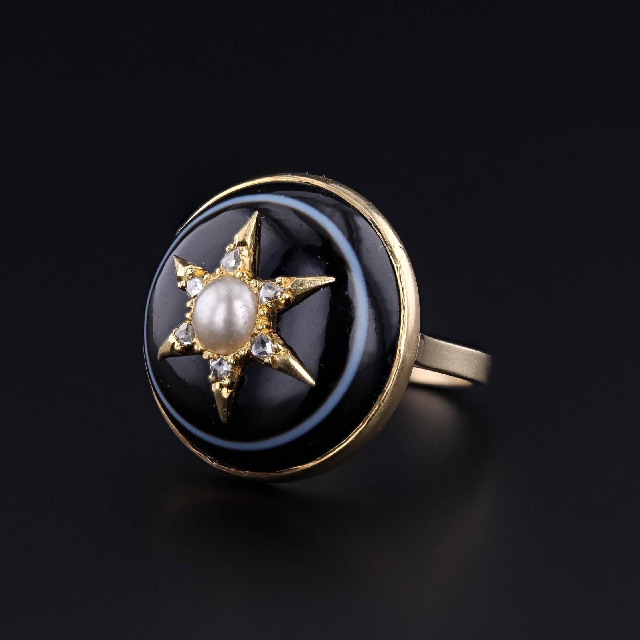 Antique Star Ring: This ring features a pearl and diamond star on a black, banded agate. It was originally an antique stickpin (circa 1870) that our jeweler transformed by removing the pin and adding a 14k gold band.

The face of the ring measures