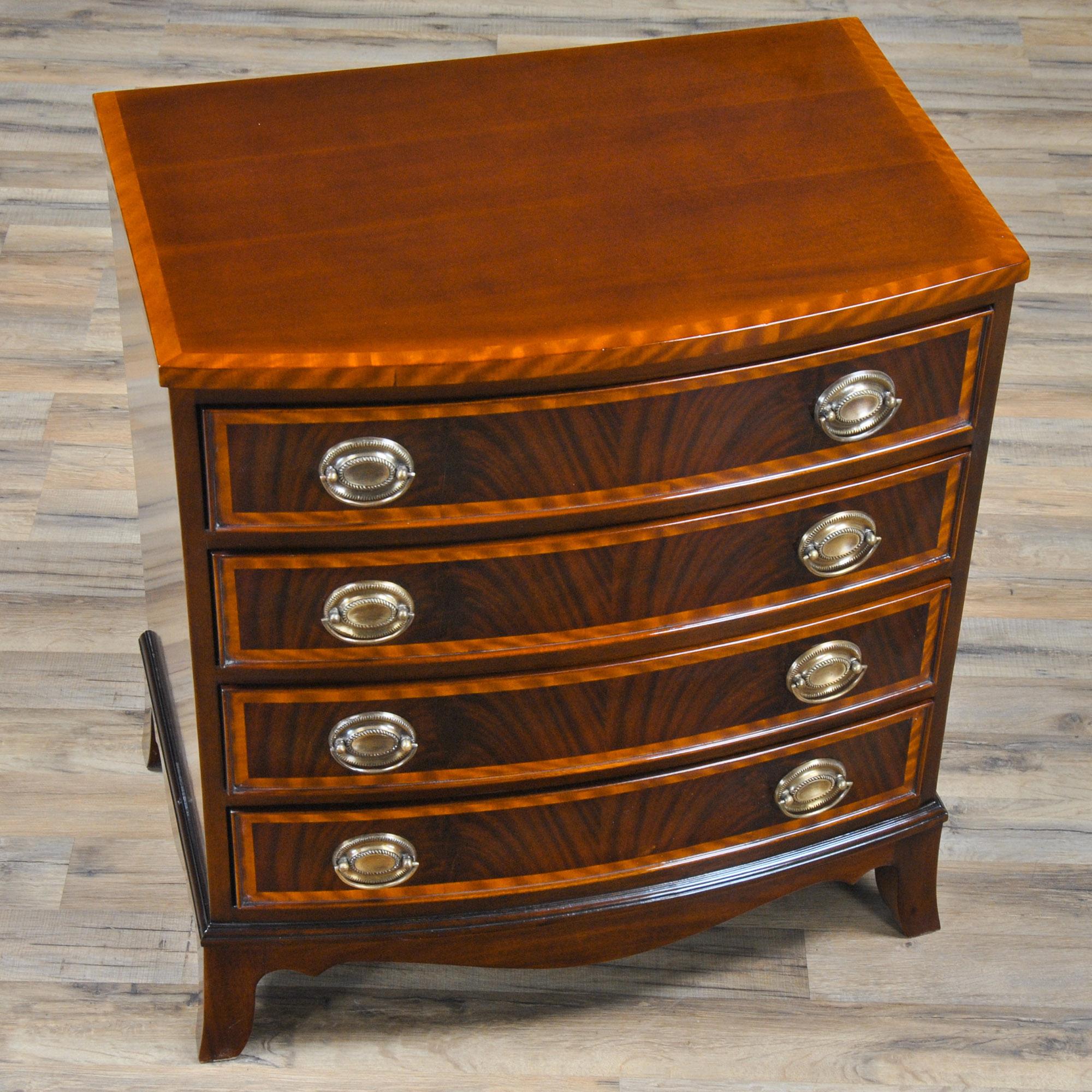 This Banded Mahogany Bowfront Chest from expresses great taste in design from the tastefully tapered legs on the floor to the finely shaped and veneer banded drawer fronts on the front and top. Graduated drawers, great mahogany and satinwood veneers