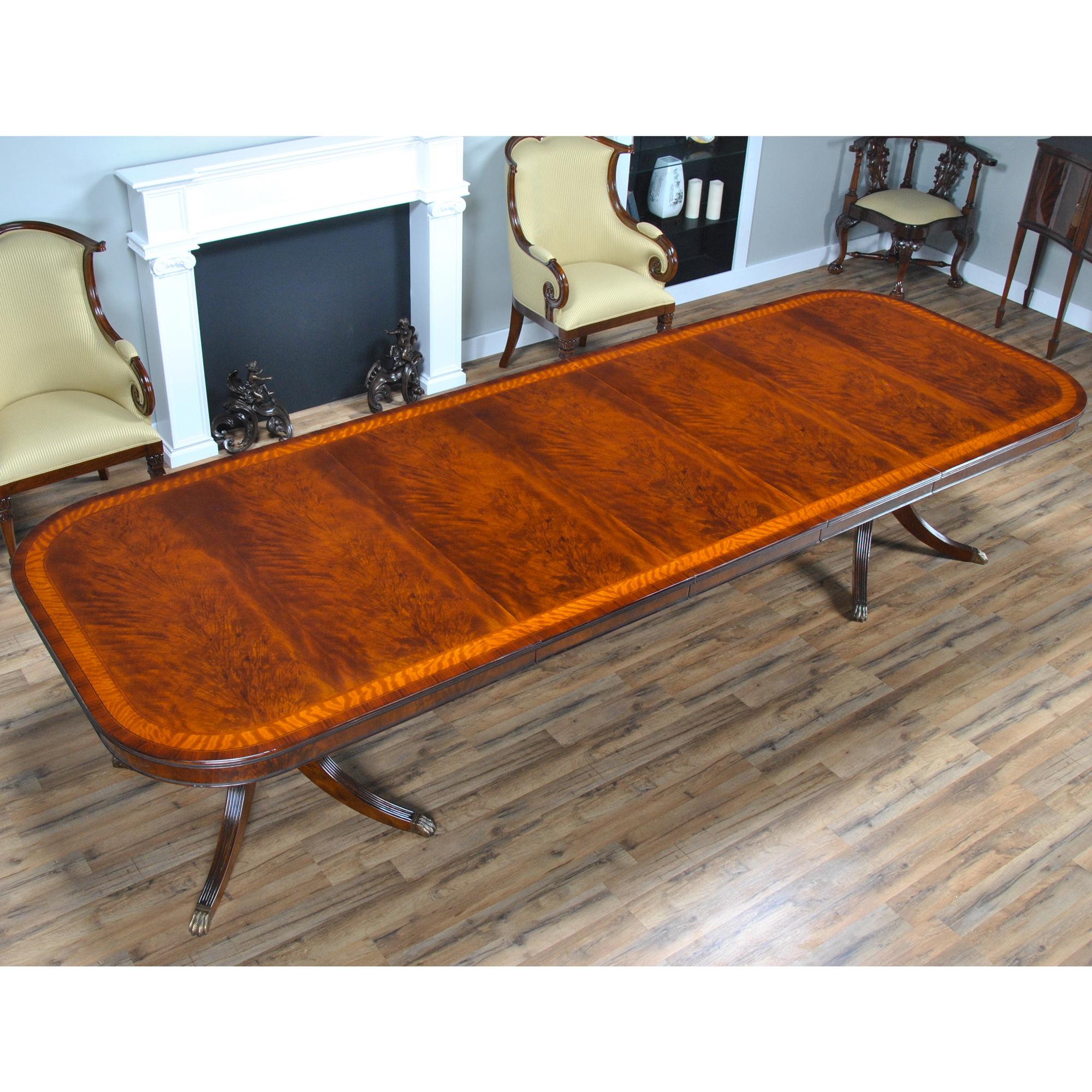 The Banded Mahogany Dining Table has a lot of great features that combine to make it a show stopper. A reeded solid mahogany edge surrounds the table top and then flows into numerous bandings consisting of rosewood, satinwood, ebony and sapele