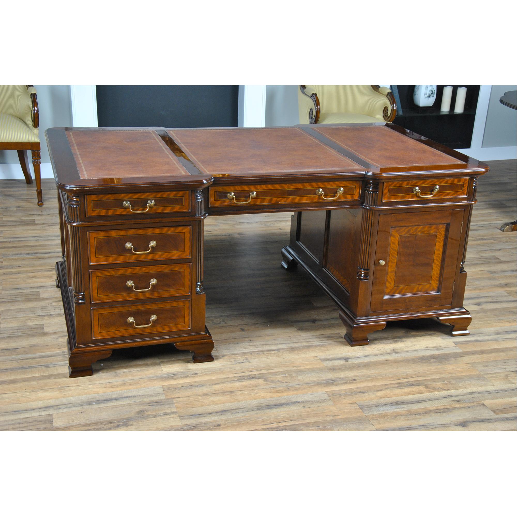 This beautiful Banded Mahogany Partners Desk is crafted as an antique reproduction. The figural mahogany in the drawer and door panels displays a rich color and a fine grain that are offset by the satinwood banding surrounding it. The three-paneled