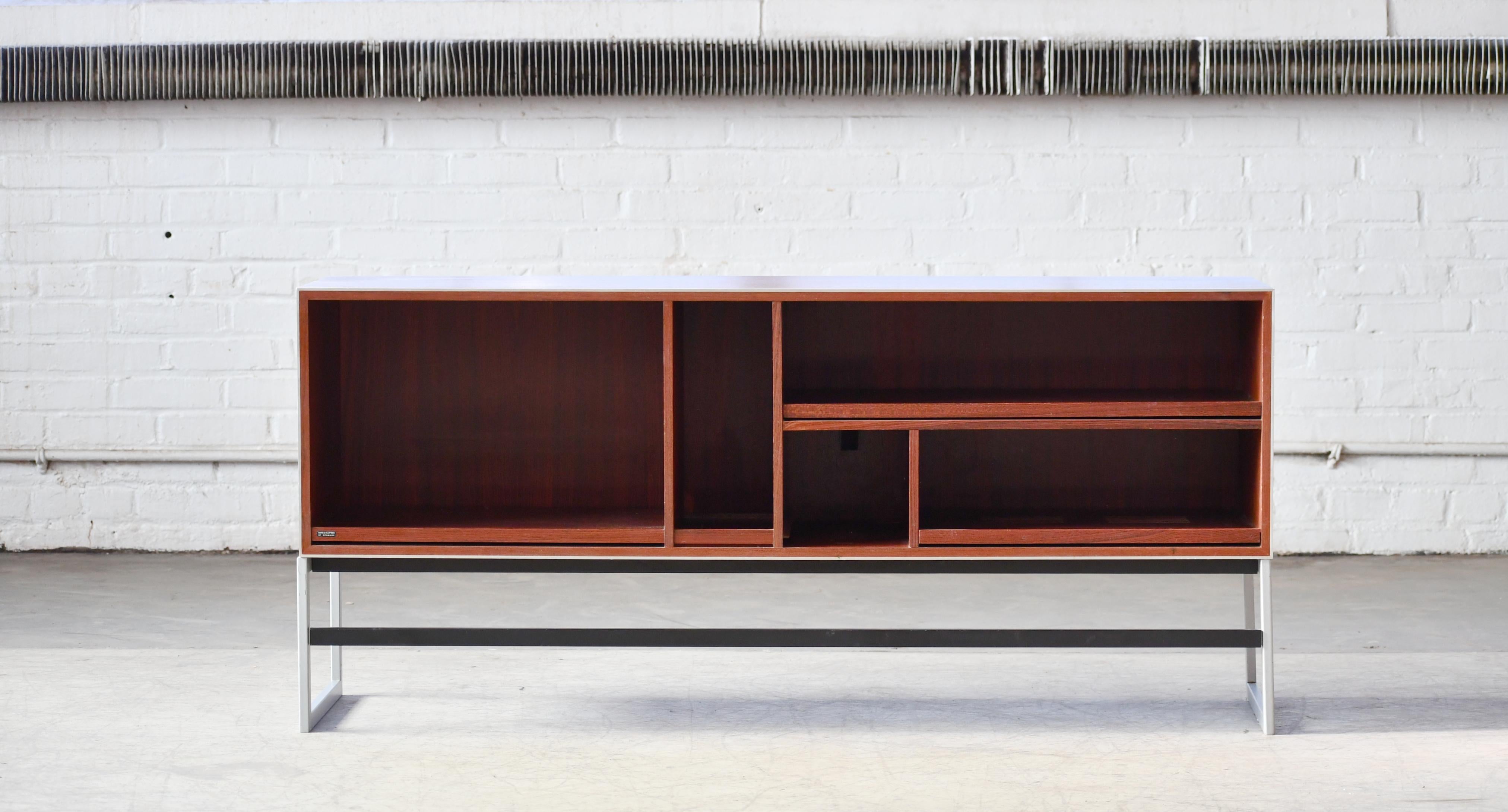 Very cool and hard to find Danish 1970s Bang & Olufsen media cabinet in rosewood and aluminum. Very functional and perfect for a turntable player. The shelves are vented to prevent overheating of stereo equipment and pull out for easy access.