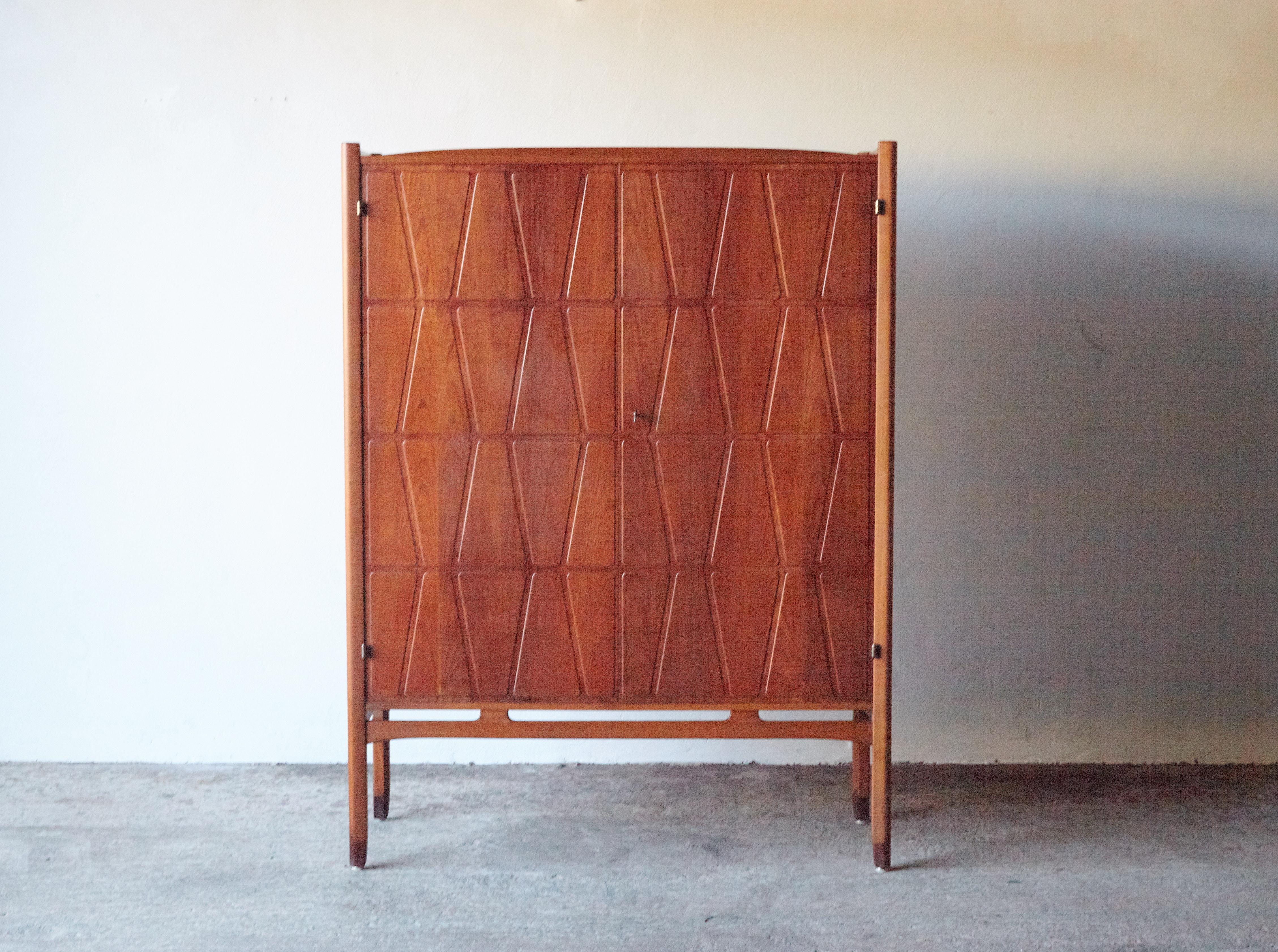 A wonderful Bangkok cabinet designed by Yngve Ekström for Westbergs Mobler, Sweden, 1950s. Solid beech legs with teak doors and sides. Inside there are three drawers and adjustable shelves. Very good original vintage condition with key present.