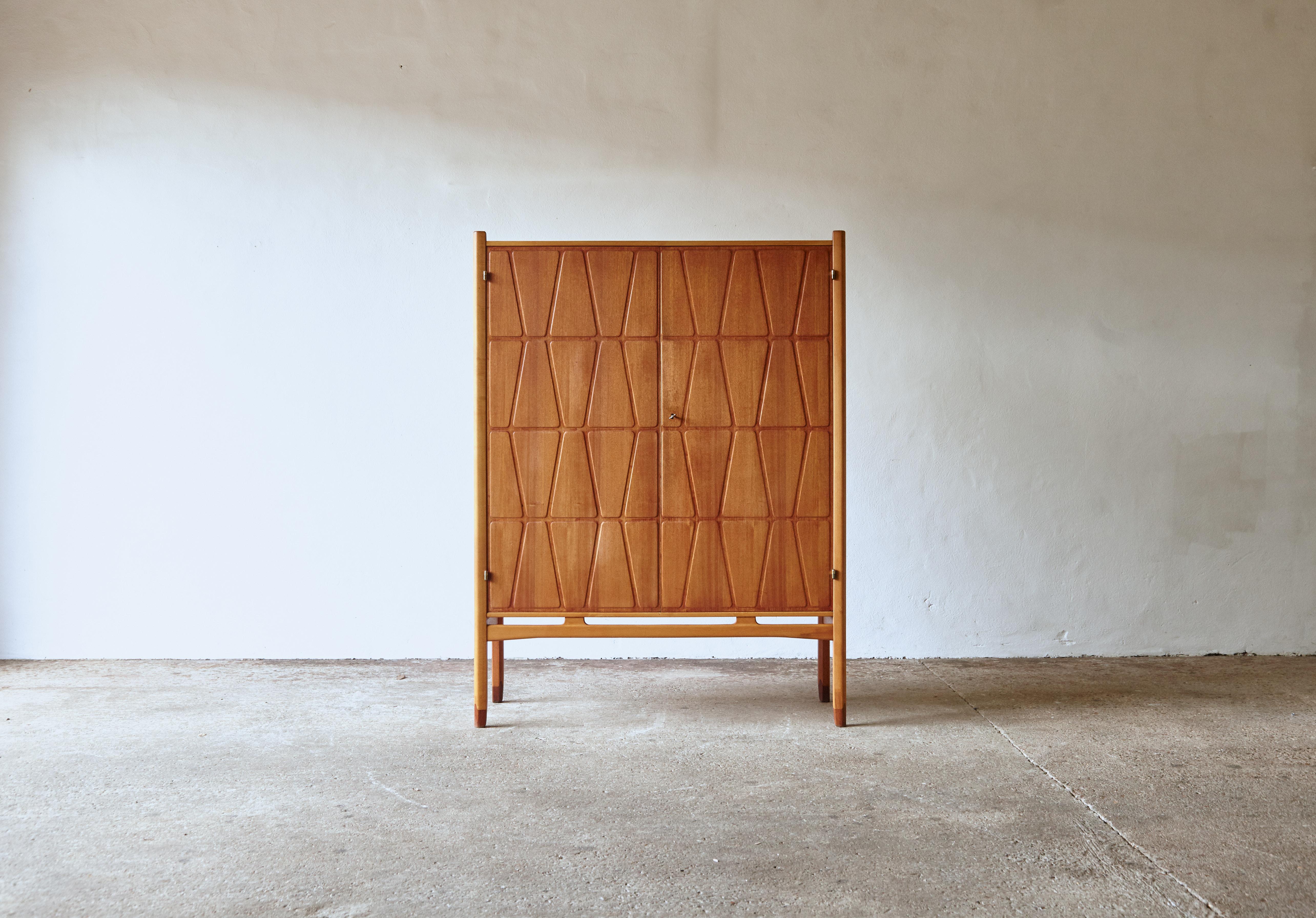 A wonderful Bangkok cabinet designed by Yngve Ekström for Westbergs Mobler, Sweden, 1950s. Solid beech legs with teak doors and sides. Inside there are three drawers and adjustable shelves. Very good original vintage condition with key present.  