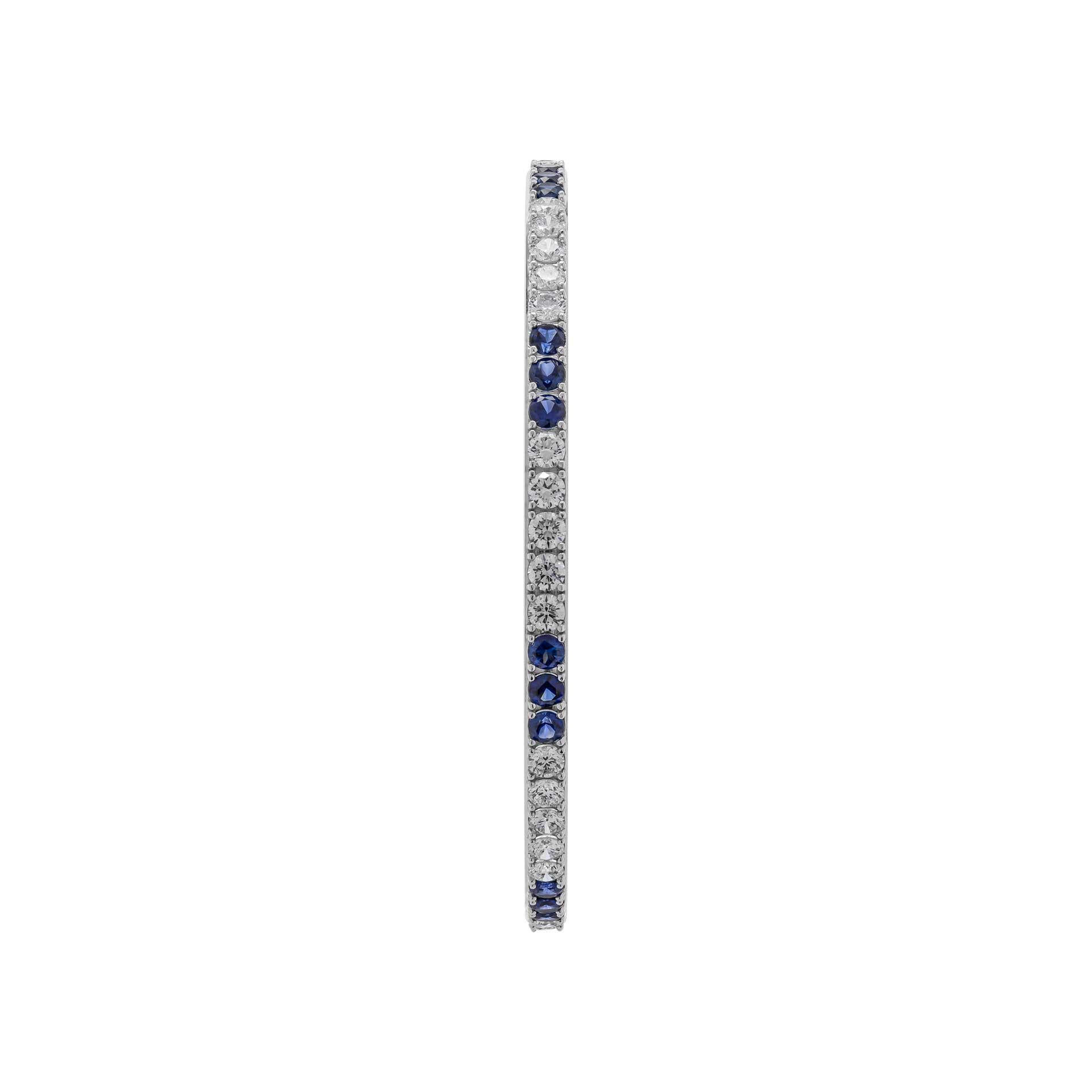 Timeless and modern, twinkles like a nighttime city skyline. 
Dazzling diamonds & sapphires trace this classic bangle.
 14k white gold with round brilliant diamonds & sapphires 
 
TCW: 4.37ct 40 diamonds 
TCW: 3.14c  24 sapphires
 Size medium (2.5