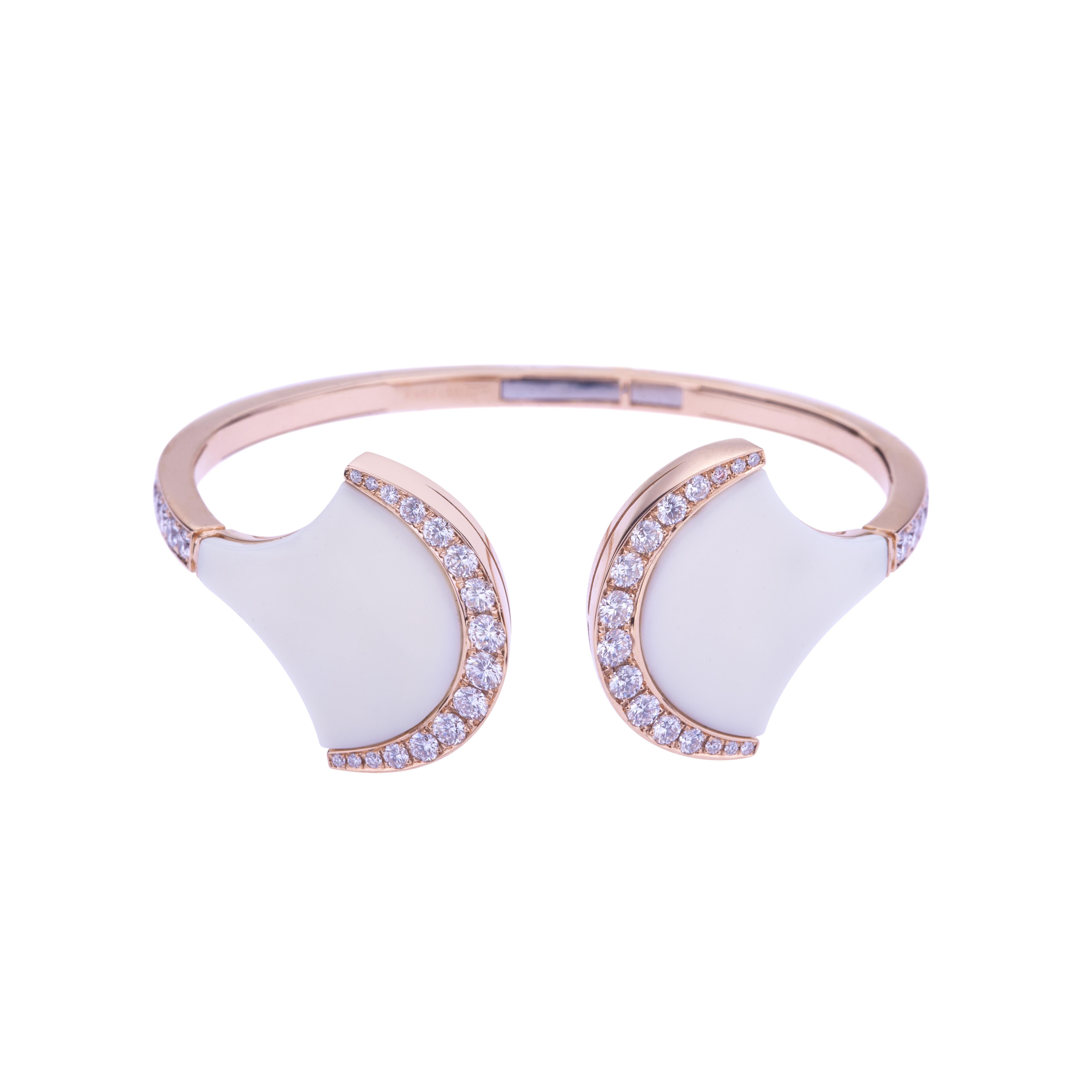 Exclusive Wave Bangle Rose Gold with White Ceramic and Diamonds.
Everyday fashionable Bangle  with Glossy Ceramic and Diamond ct. 1.87 G-SI. 18kt Gold is around  15 grams. 
Angeletti Boasts an Exceptional History Made of Pure Jewelry Tradition, a