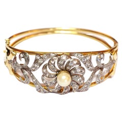 Bracelet jonc en or jaune et blanc 18 carats avec fleurs et perles
