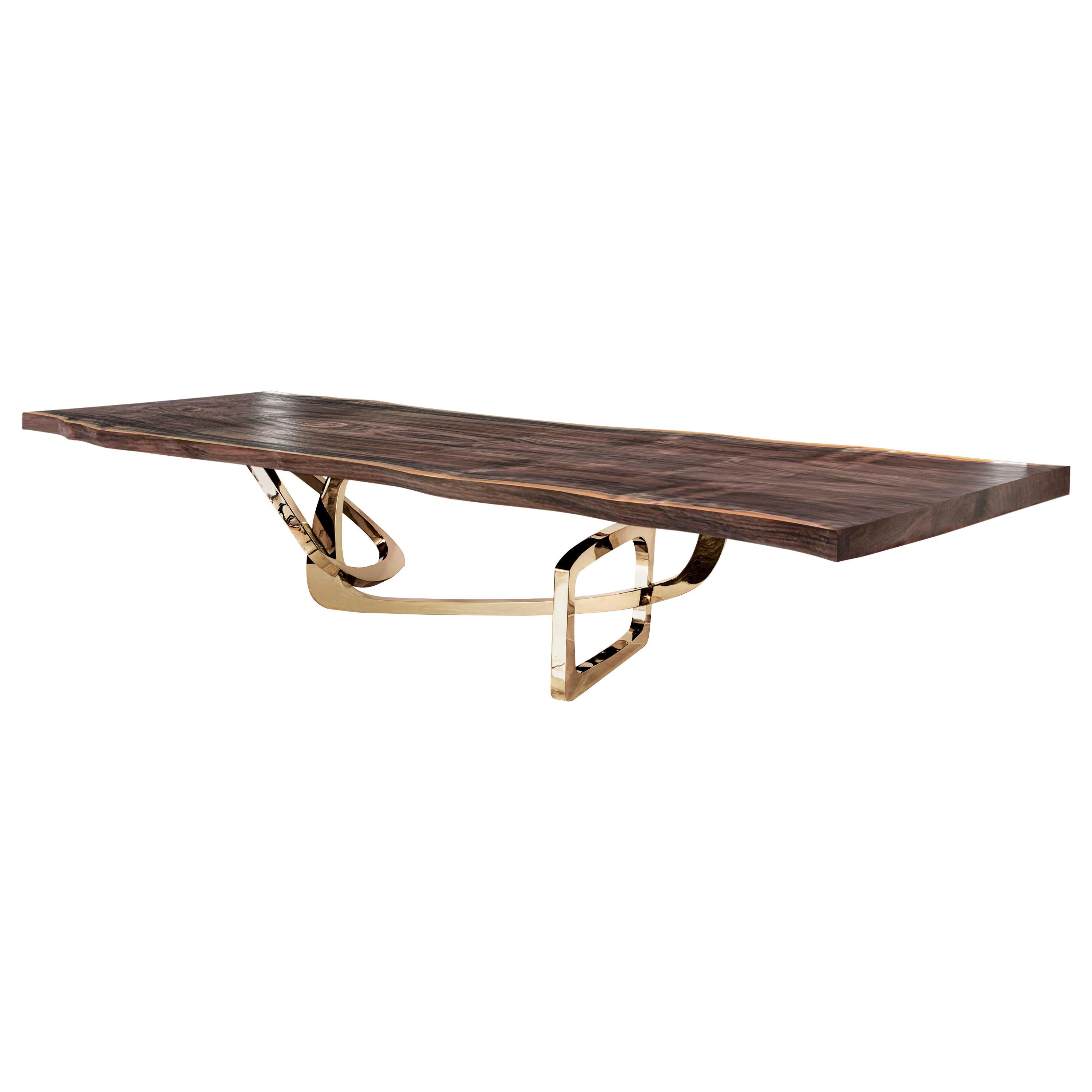 The Bangle dining table by Barlas Baylar is a contemporary interpretation of Art Deco design inspiration by utilizing rigorous craft.  The sculptural Stainless Steel base and Solid Walnut top  is available in a variety of finishes.  The top can be