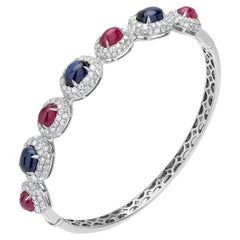 Bangle in 18 Karat White Gold with 7.26 Carat Ruby, Blue Sapphire, and Diamond
