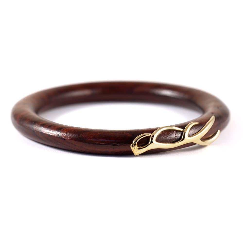 Objects Organique bangle in Cocobolo wood and 18 karat yellow gold antler motif.

The Objects Organique Collection is an invitation to connect with the elements—Earth, Air, Fire, Water. This one-of-a-kind creation integrates pure power from nature
