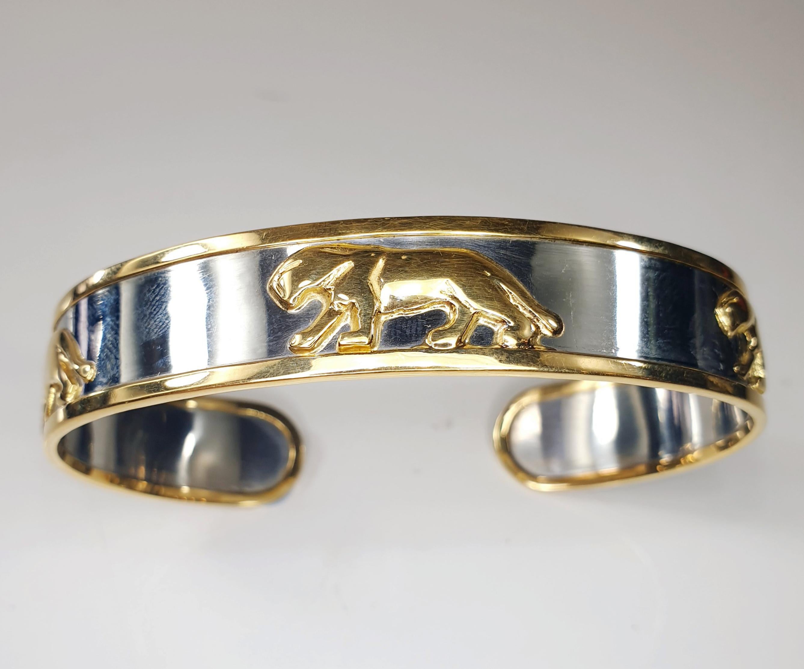 One of the most stylish designs, this classic and estament  Panther Bangle bracelet
Crafted in stainless steel and  18k Yellow Gold
weights 22,8 grams.
Size for medium wrists lenght  17cm 6,69inches x 1cm  0,39 inches

Panthers represent stealth,