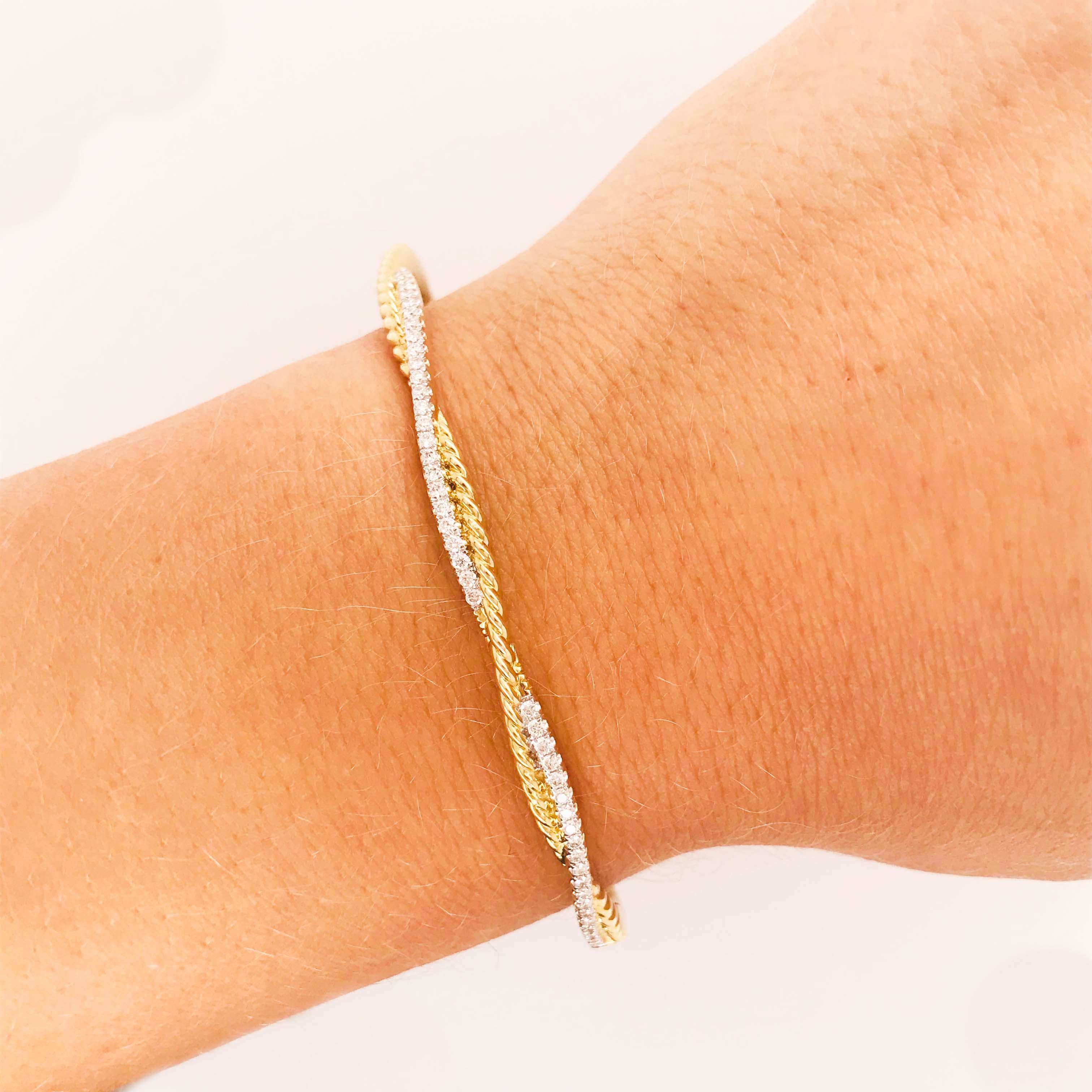 This diamond bangle bracelet is a twist design with a mix of 14 karat white and 14 kt yellow gold.  The luscious twisted rope design is lovely paired with a white gold thread that has diamonds all the way around.  This bracelet will fit an extra