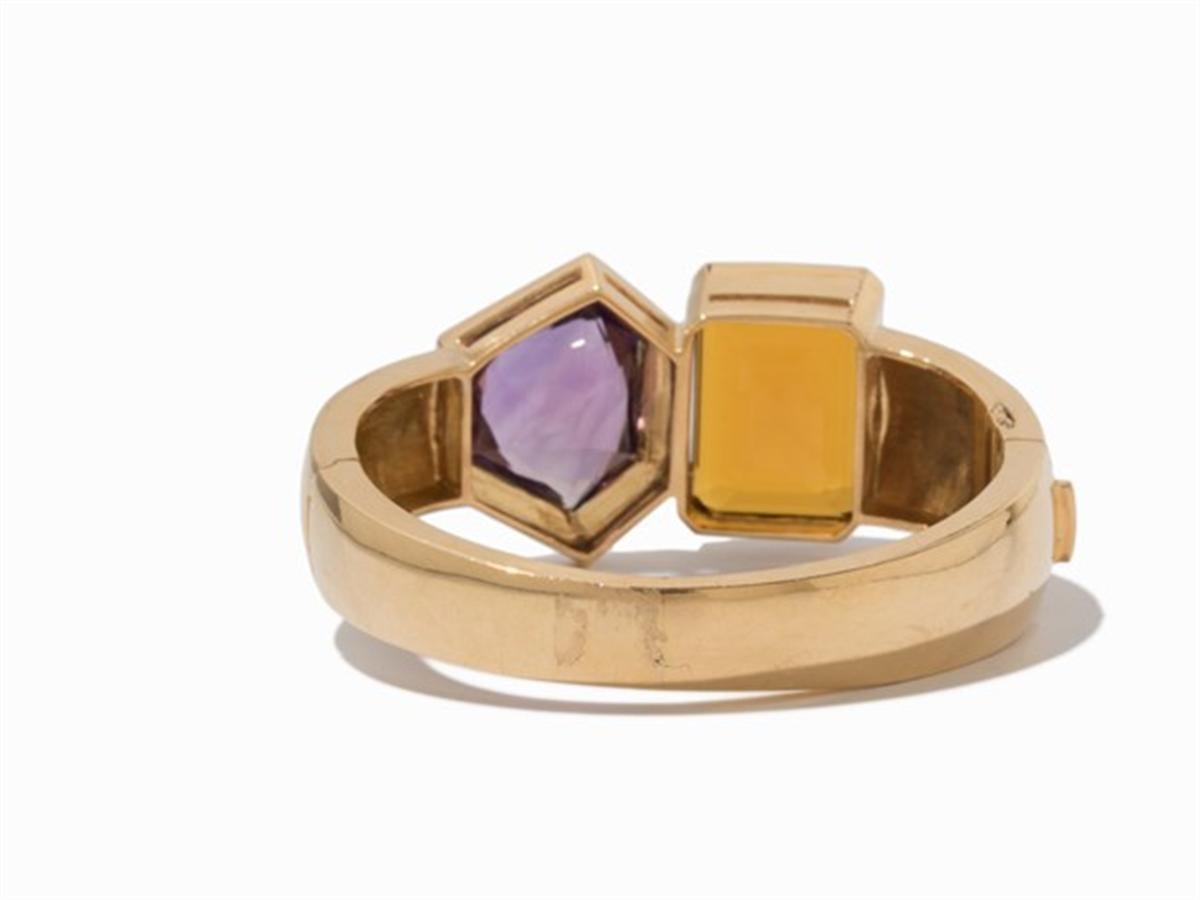  delineation
- 750 yellow gold

- Punched with the fineness
- An emerald-cut citrine of approx. 41 ct
- An amethyst in fancy cut of approx. 35 ct
- inner circumference: approx. 18 cm
- Weight: approx. 86 g
- This statement bracelet is a real