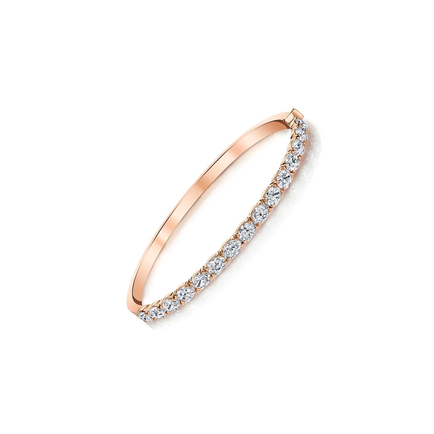 15 Oval-cut diamonds set in 18k rose gold 4-prong bangle bracelet. 
Carat total weight 4.51
GIA Color D-F Clarity VVS2-VS2 
Also available in 18k white and yellow gold.
