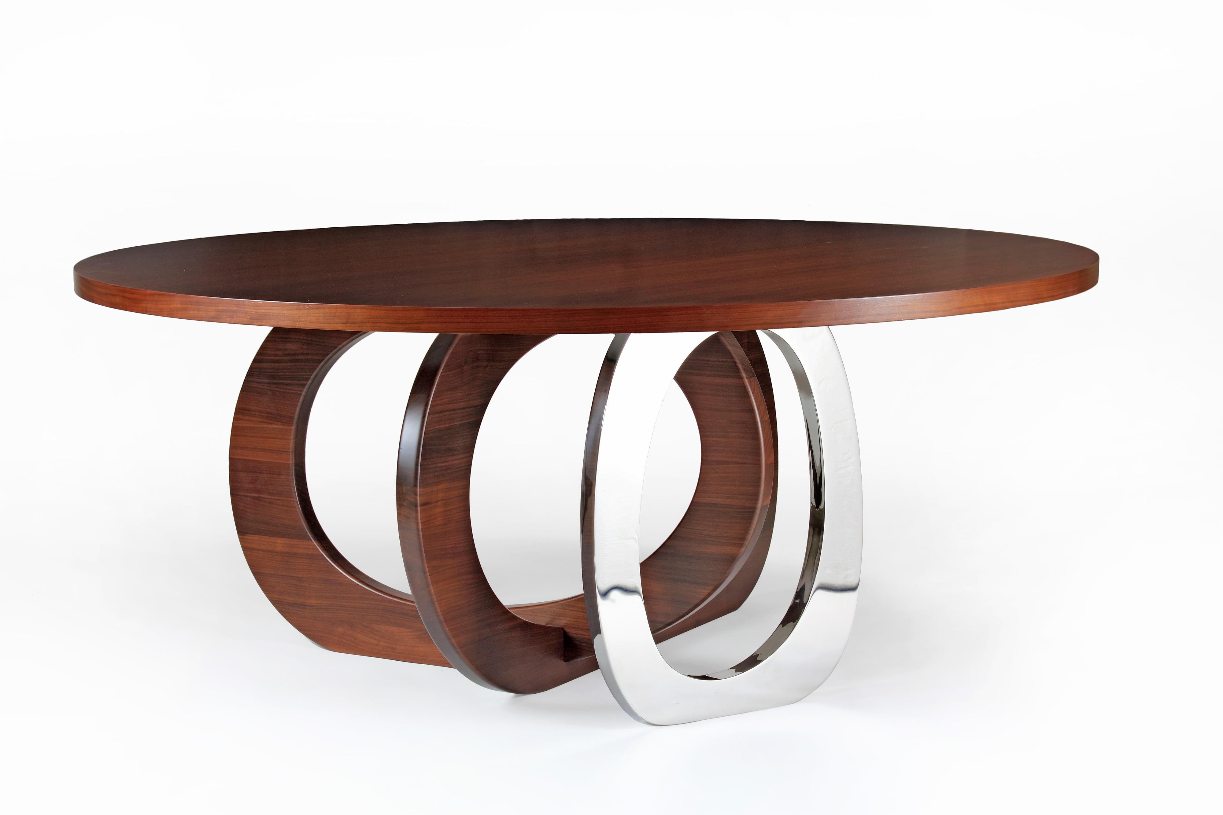 Bangles Kelowna Dining Table by Barberini & Gunnell
Dimensions: D 180 x H 75 cm.
Materials: Solid American walnut, mirror-polished stainless steel.

Round table with two rings in solid wood and a single ring in mirror-polished stainless steel AISI