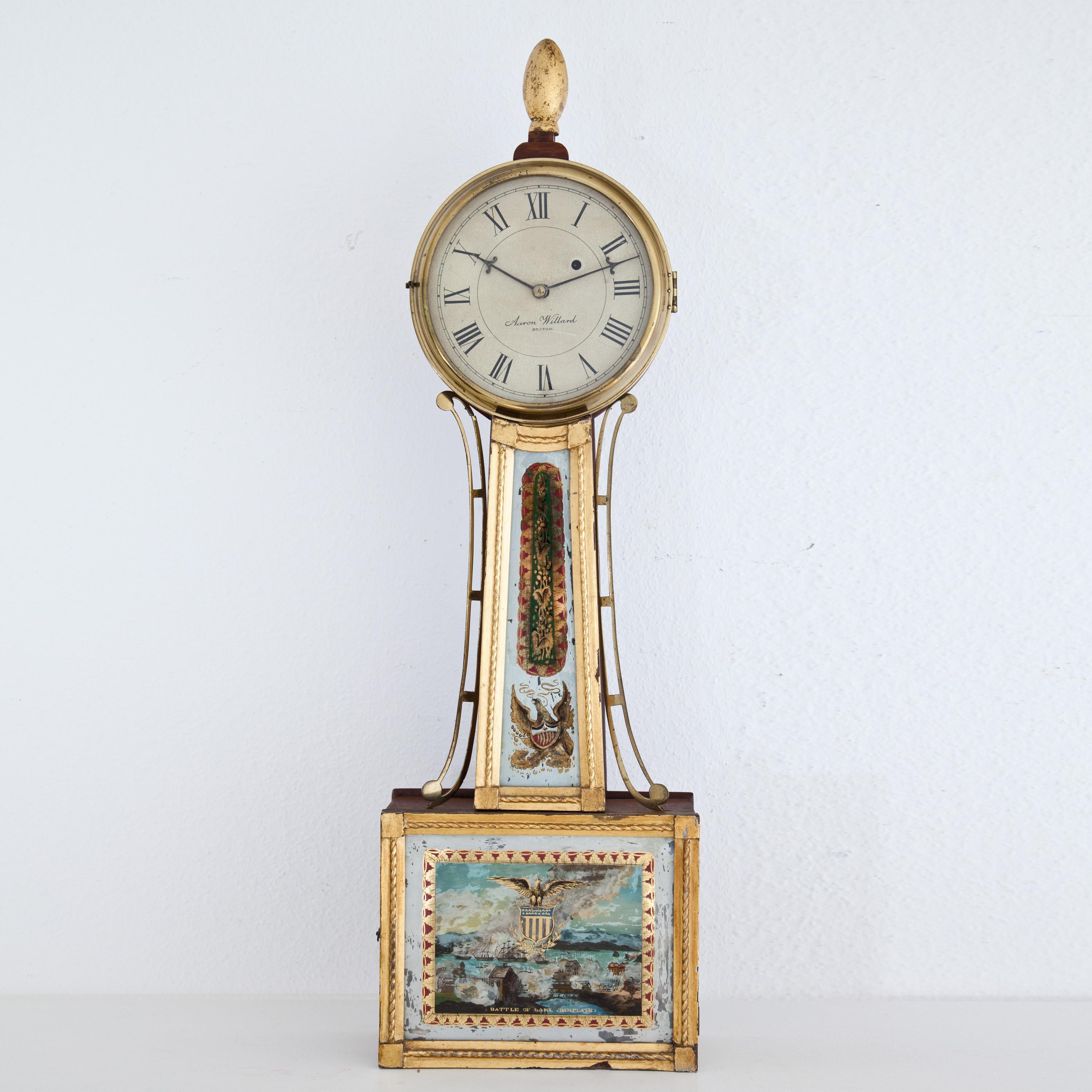 Banjo clock on rectangular, partly gold patinated pendulum case with Verre églomisé paintings, below 