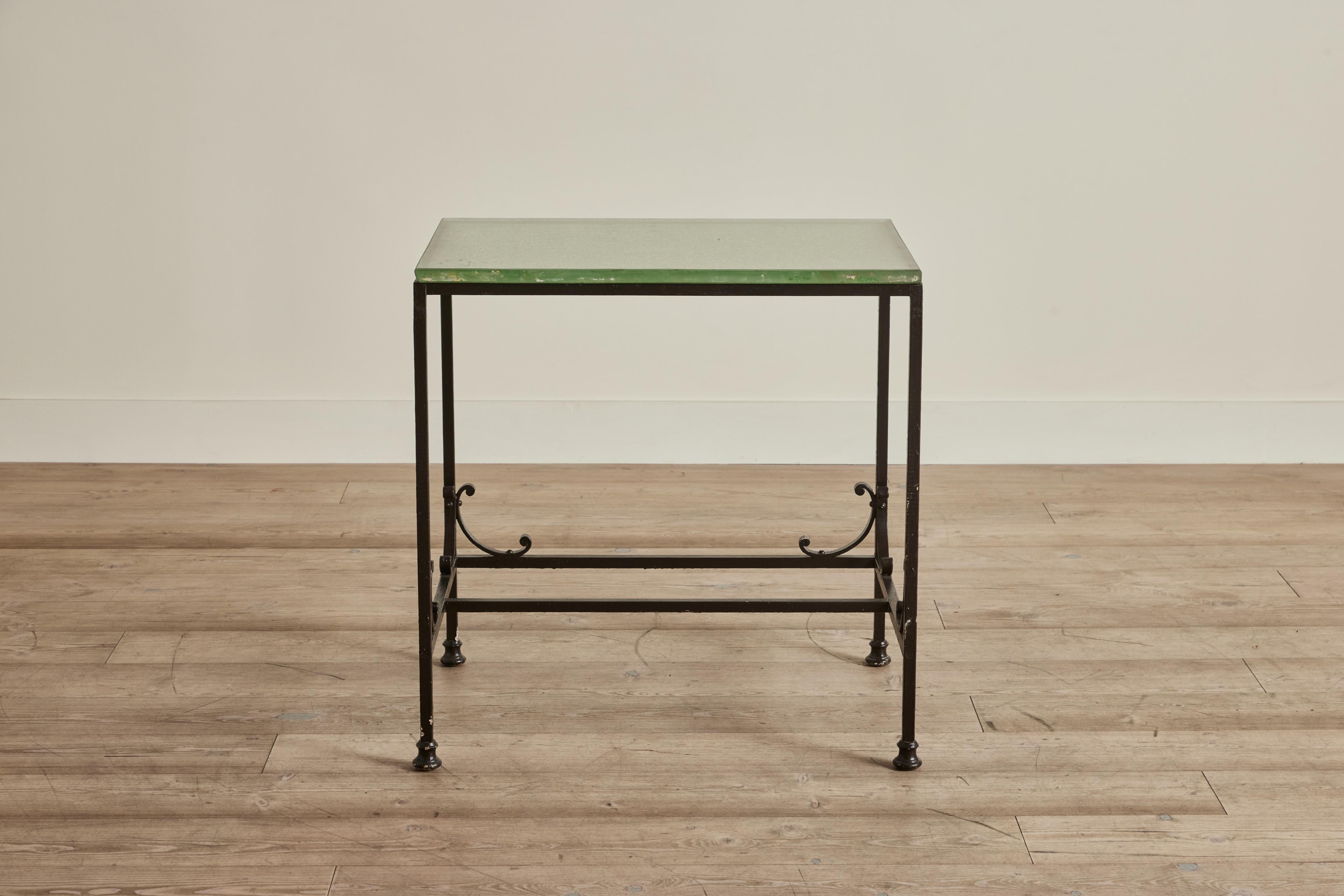Early 20th century bank side table made from thick glass and wrought iron. Wear throughout on iron and glass that is consistent with age and use. 

