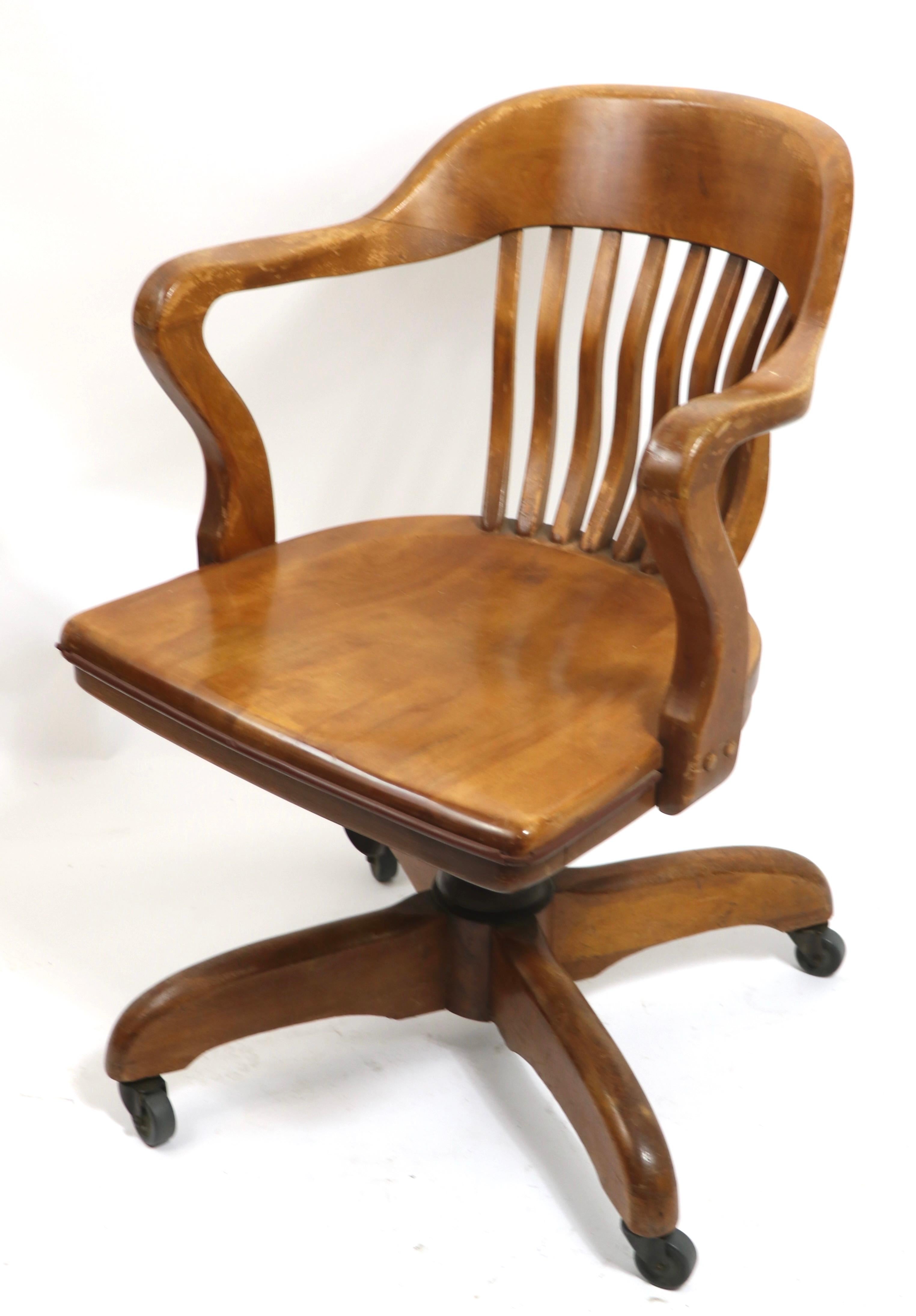 Swivel desk, office chair attributed to Gunlocke. The chair is adjustable in height, and also swivels and tilts to adjust position. This example is solid walnut, it is in very good, original, clean and ready to use condition. Attributed to Gunlocke,