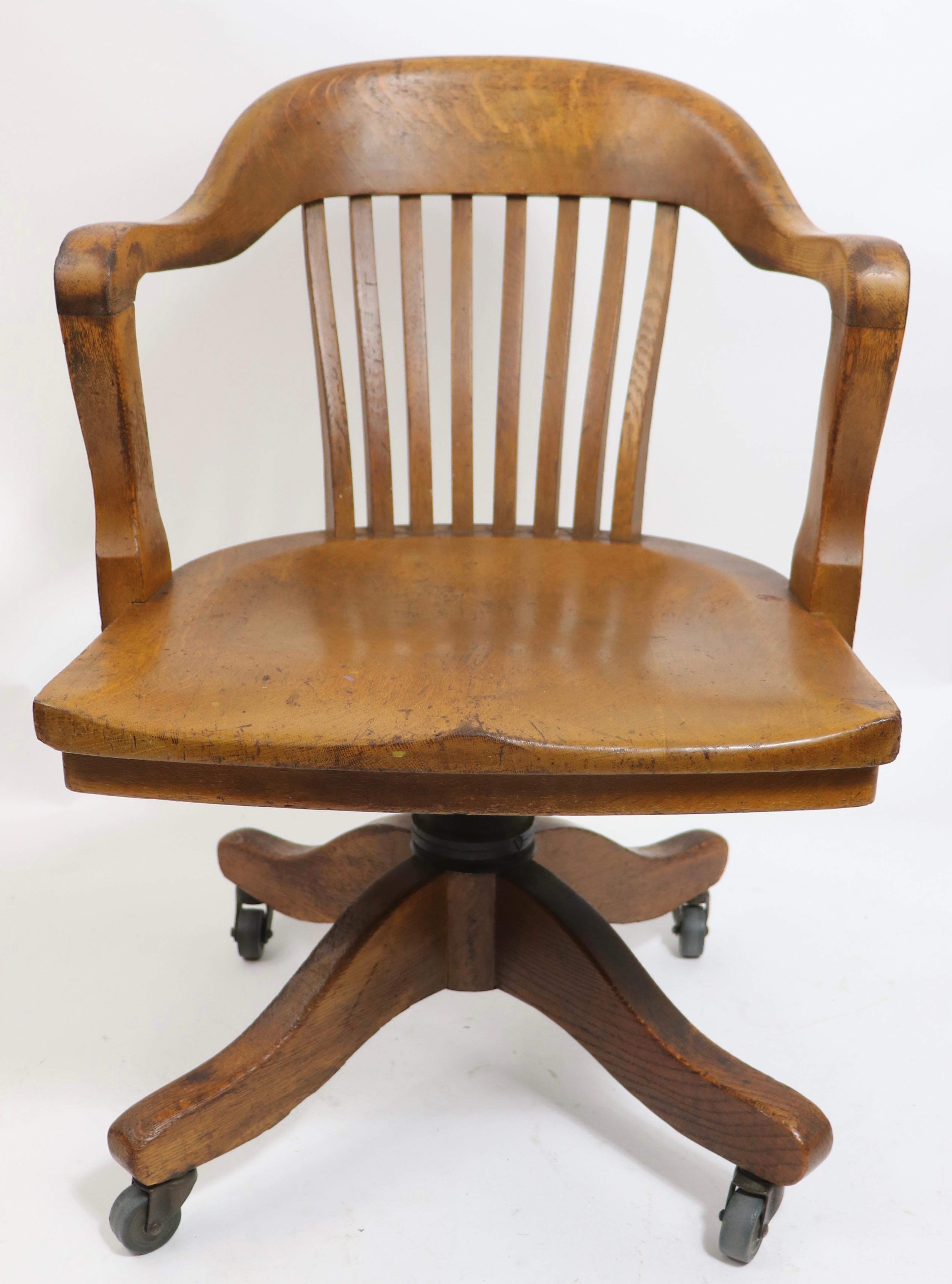 Bank of England, Yale Library, Jury desk chair, in oak. This example is in very good original, clean, ready to use condition. The chair is adjustable in height, it also swivels and tilts. 
 Total H in Extended Position 35
 Seat H in Extended