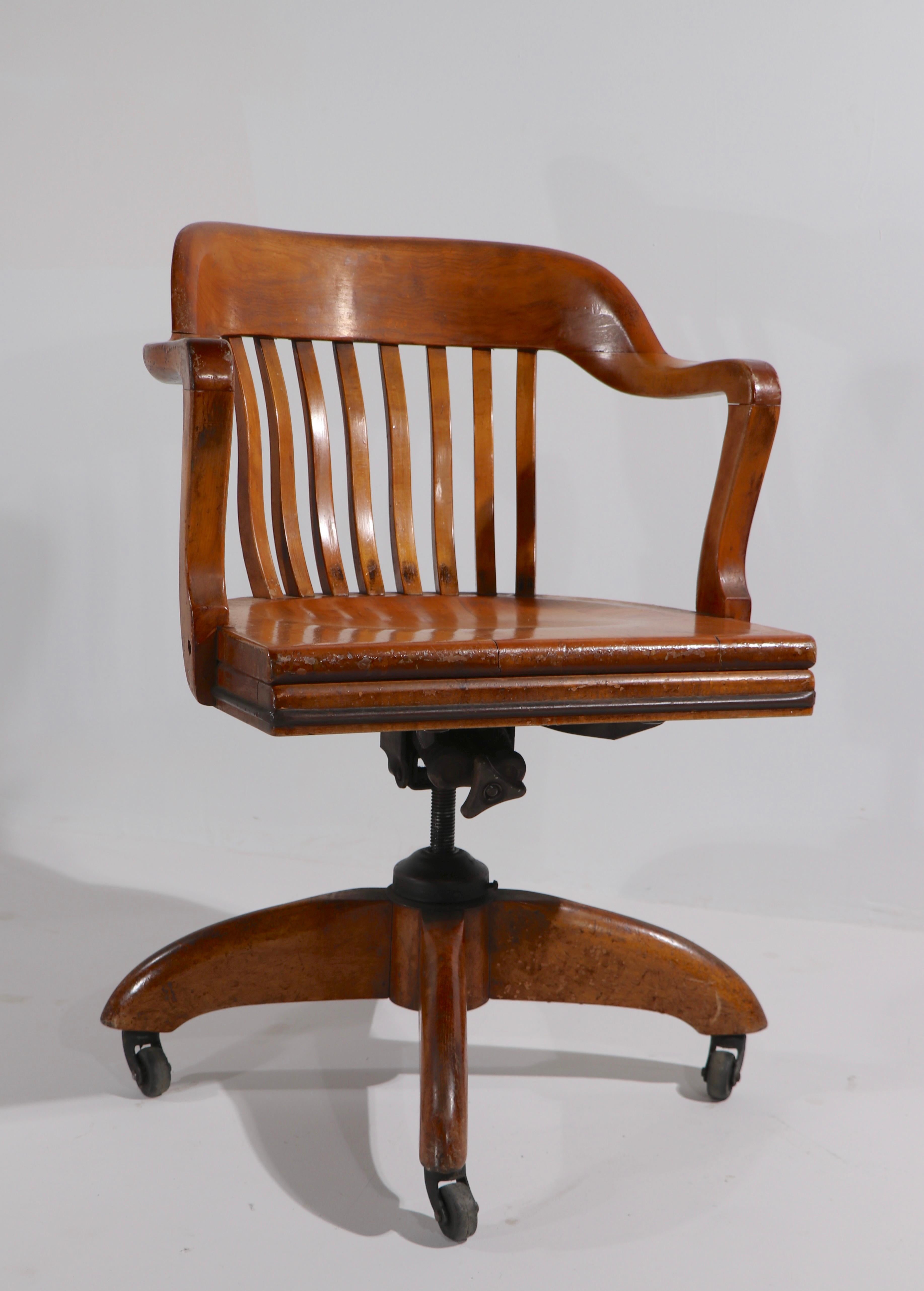 Nice antique swivel, tilt adjustable desk, office chair having a four star base. This example is adjustable in height, seat H in lowest position 18 inch x seat H in highest position 21.5 inch. The chair is structurally sound and sturdy, the finish