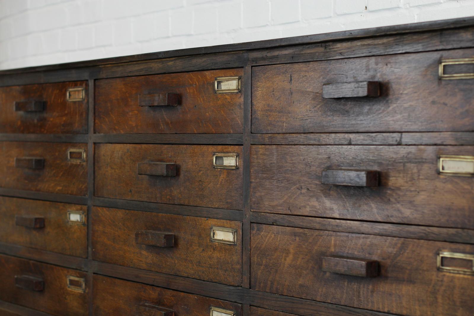 Bank of French oak museum drawers, circa 1920s.

- Pine top and sides with solid oak drawers
- Fine dovetail joints
- 24 large drawers
- Some of the drawers retain their original hand written labels
- Original oak handles
- Brass card